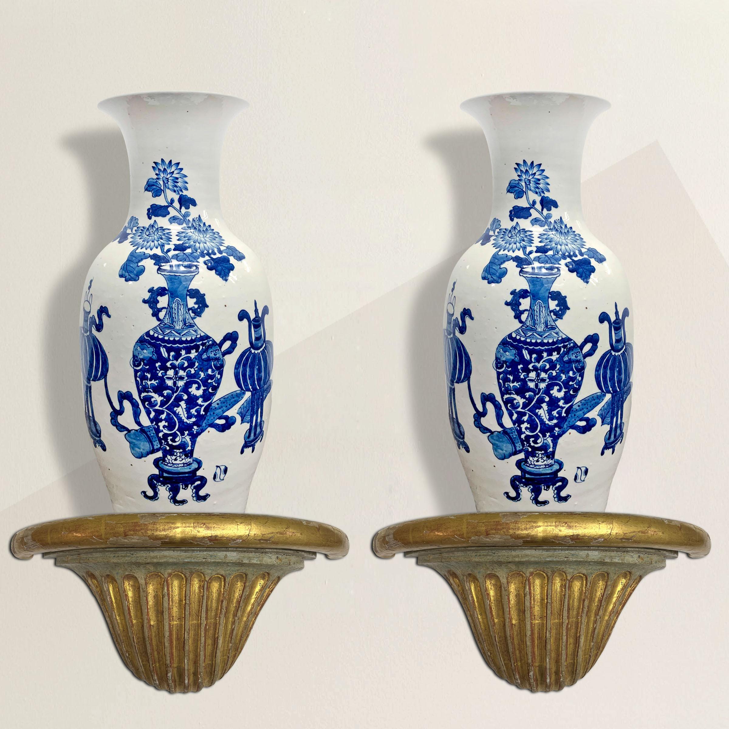 An exquisite pair of 18th century French Louis XVI wall brackets with water-gilt highlights, fluted bases that resemble shells, and faux-marble painted tops. Perfect for flanking a mirror in your entry and displaying your favorite pair of urns or