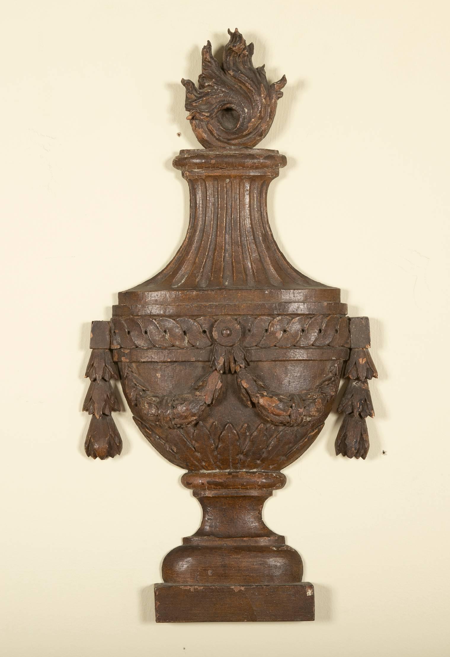 Pair of late 18th century French carved and painted oak wall appliques in the form of urns. Each urn carved with swags and florets, with asymmetrical flames spouting from the tops.
 
Good scale at almost 2 feet high. (23.5 H bt 12 wide by 2.5 deep