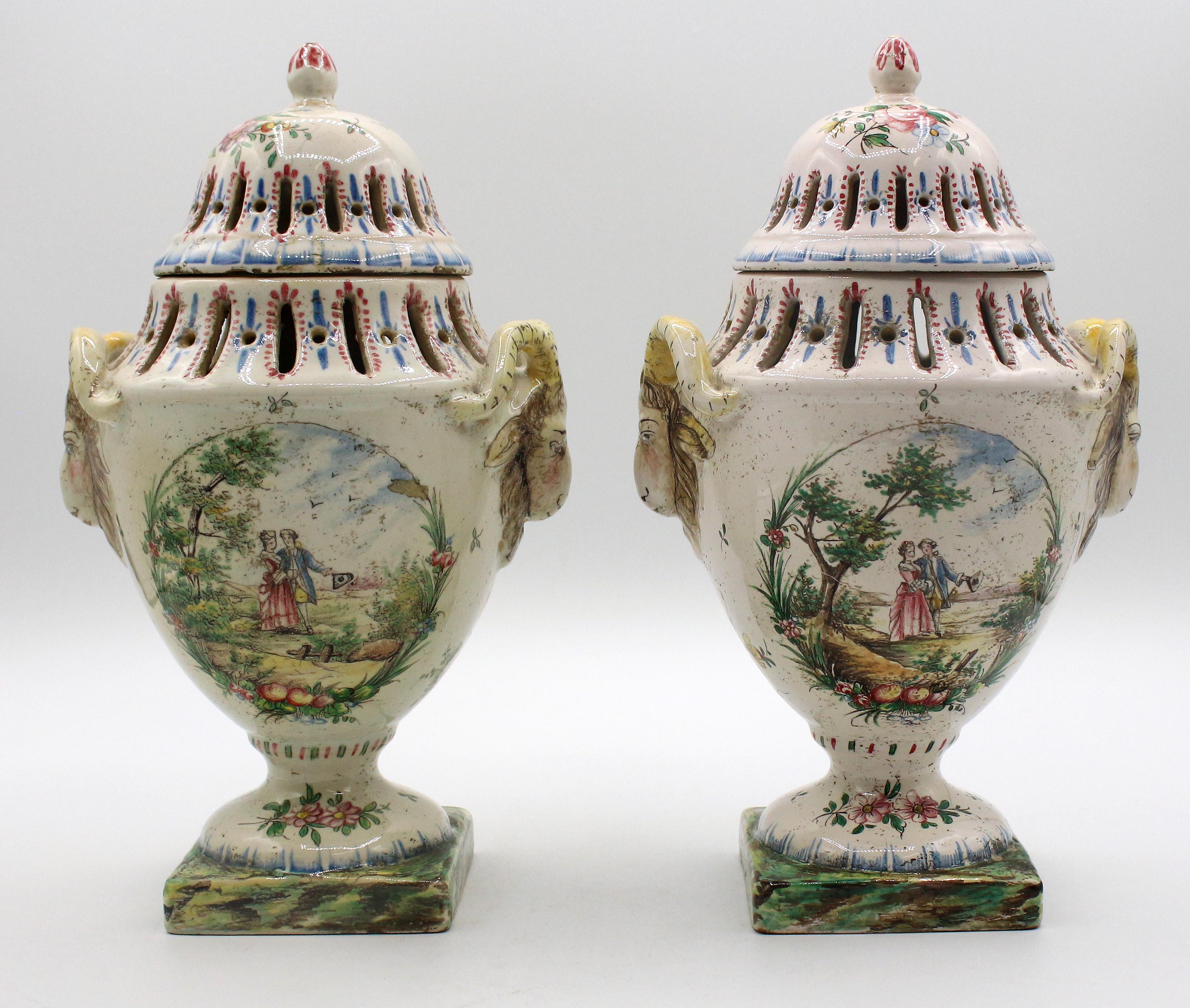 Pair of covered potpourri urns, French, last quarter 18th century. Faience. Neo-classical design & period. Goat mask handles. Romantic scene of a couple. 9 3/4
