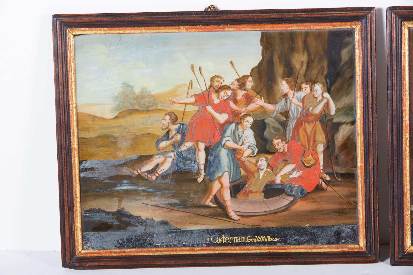 Pair of antique reverse glass paintings in original frames. These paintings depict two episodes in the Old Testament story of Joseph, one of his brothers casting him into the well and the other of his brothers presenting their father with Joseph's