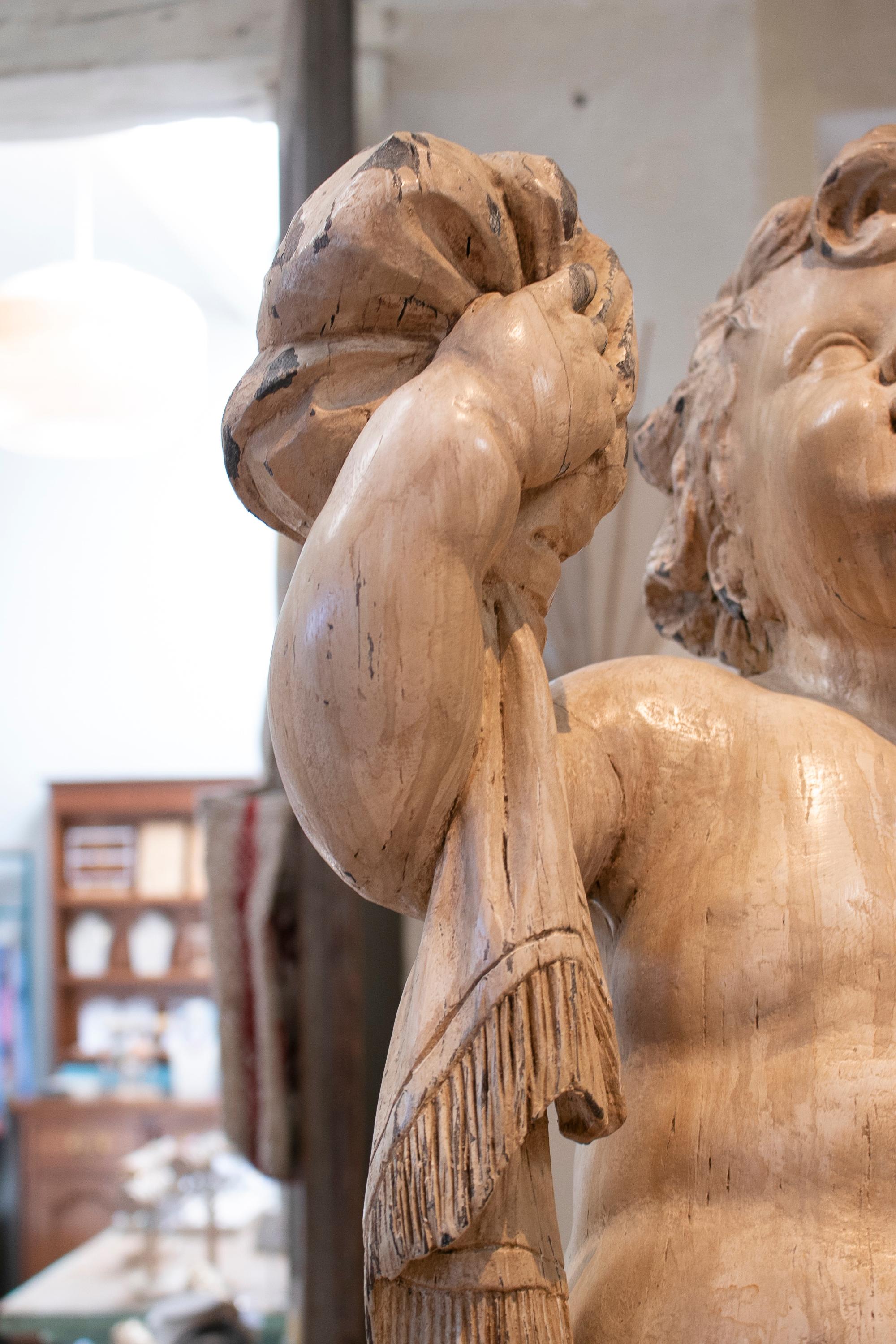 Pair of 18th century hand carved and painted wooden putti cherubs.