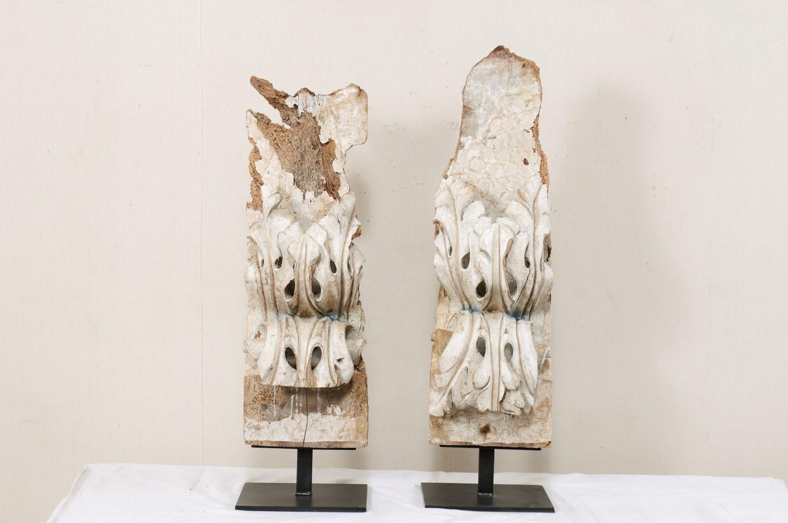 A pair of Italian carved-wood fragments from the 18th century, mounted on custom stands. These antique wooden fragments from Italy have been heavily hand carved in a three-dimensional scroll and acanthus leave motif. The carvings project out from