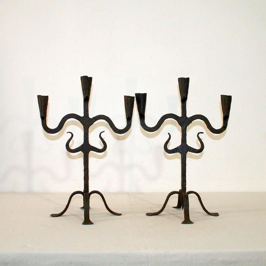 Beautiful and rare pair of hand-forged iron candleholders, Southern France/ Northern, Spain, 18th century. Weathered.