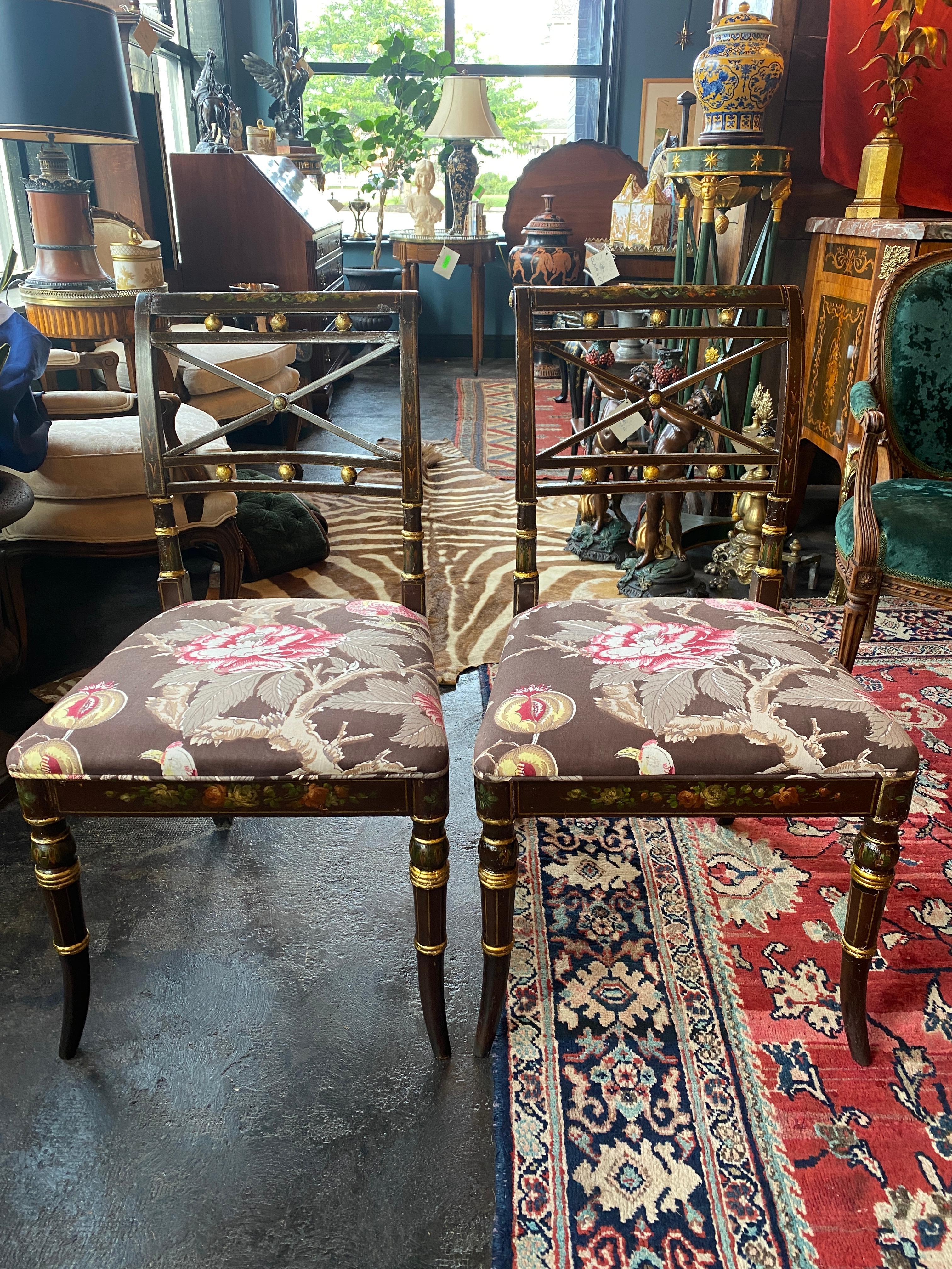 A pair of period Adams side chairs from the late 18th Century. Both are hand painted with foliate design and gilt accents. The original cain seats have been replaced with Chinoiserie style upholstered seats. Both are in good condition and could be
