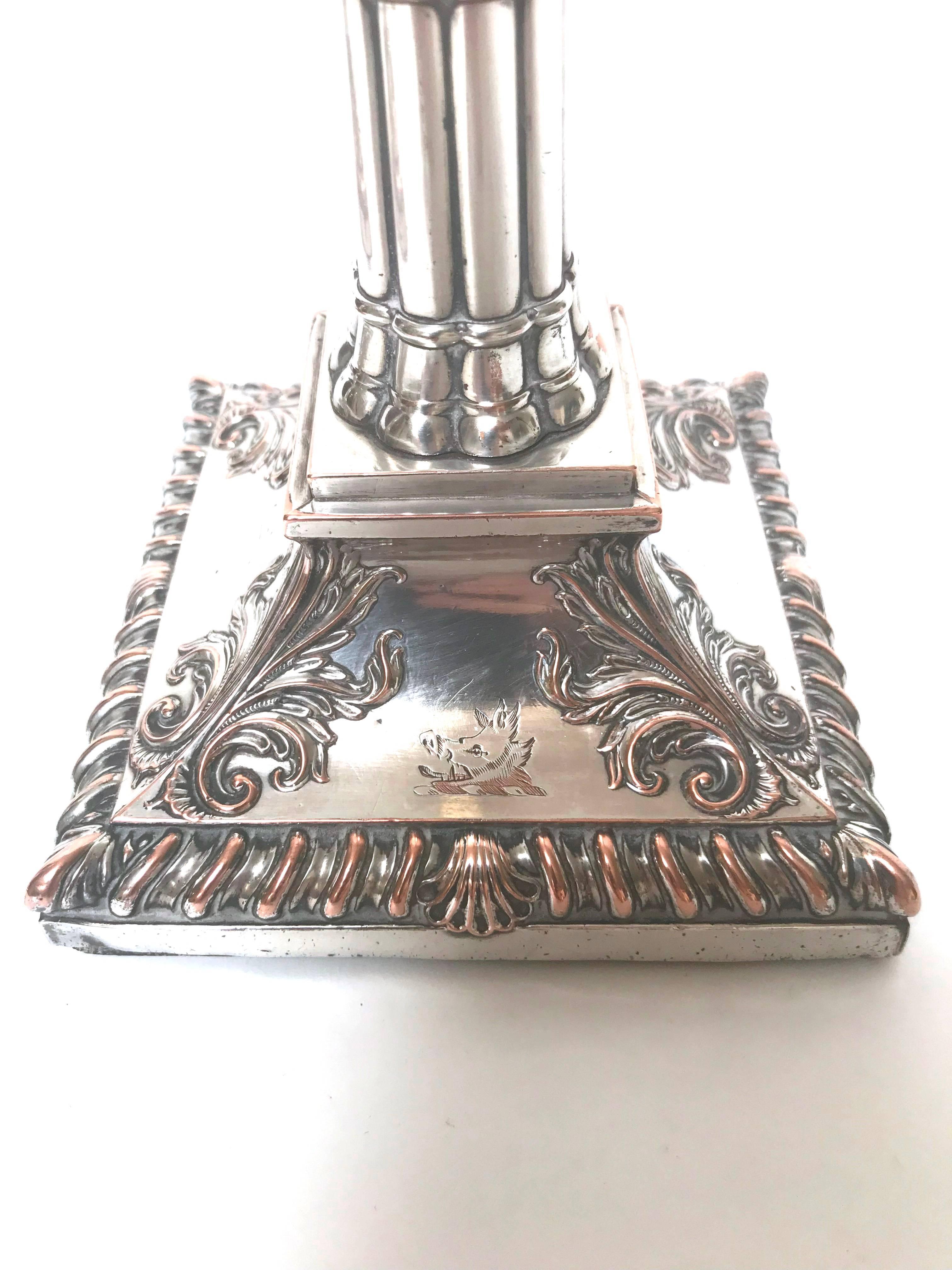 A stylish pair of Irish, 18th century silver plate candlesticks, marked JL and LAW, indicating a collaboration of silversmiths William Law (active 1770-1780) and John Lloyd (active 1760-1780) of Dublin, Ireland. These are weighted, each with a