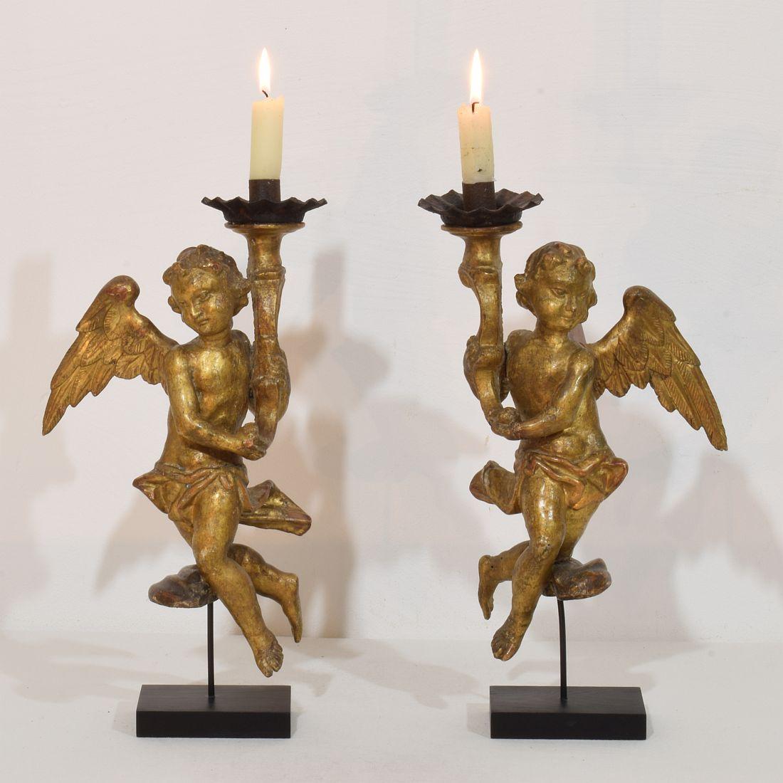 Attractive  pair of small angels with candleholders, Italy, circa 1750. Weathered, small losses and old repairs.
More pictures available on request. Measurements are individual and include the wooden base.