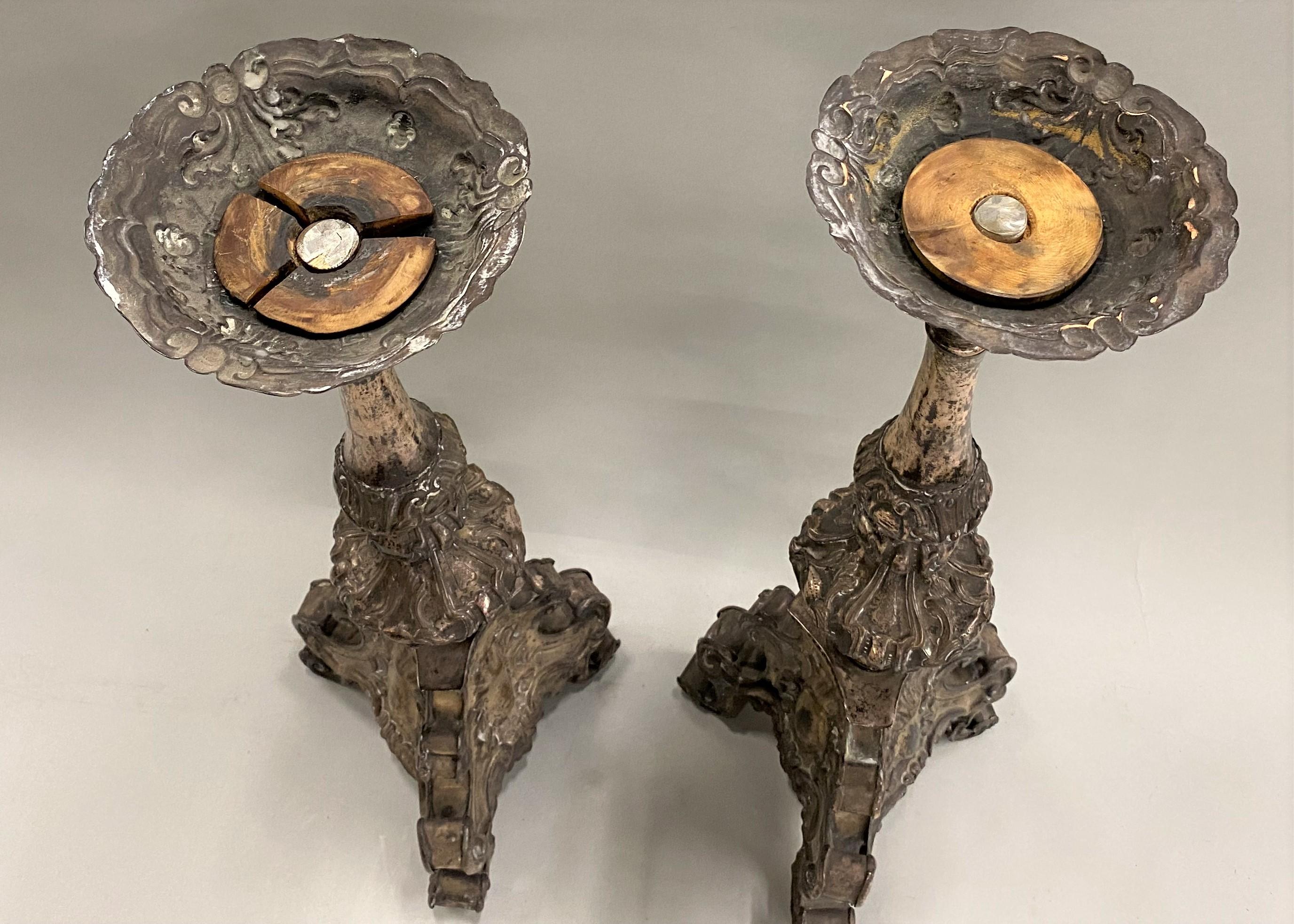 A nice pair of 18th century Italian Baroque style pressed metal candlesticks with metal over wood tripod bases, converted to lamps at some point, but now with wiring and lamp fittings removed (new hardware installed). Good overall condition, with