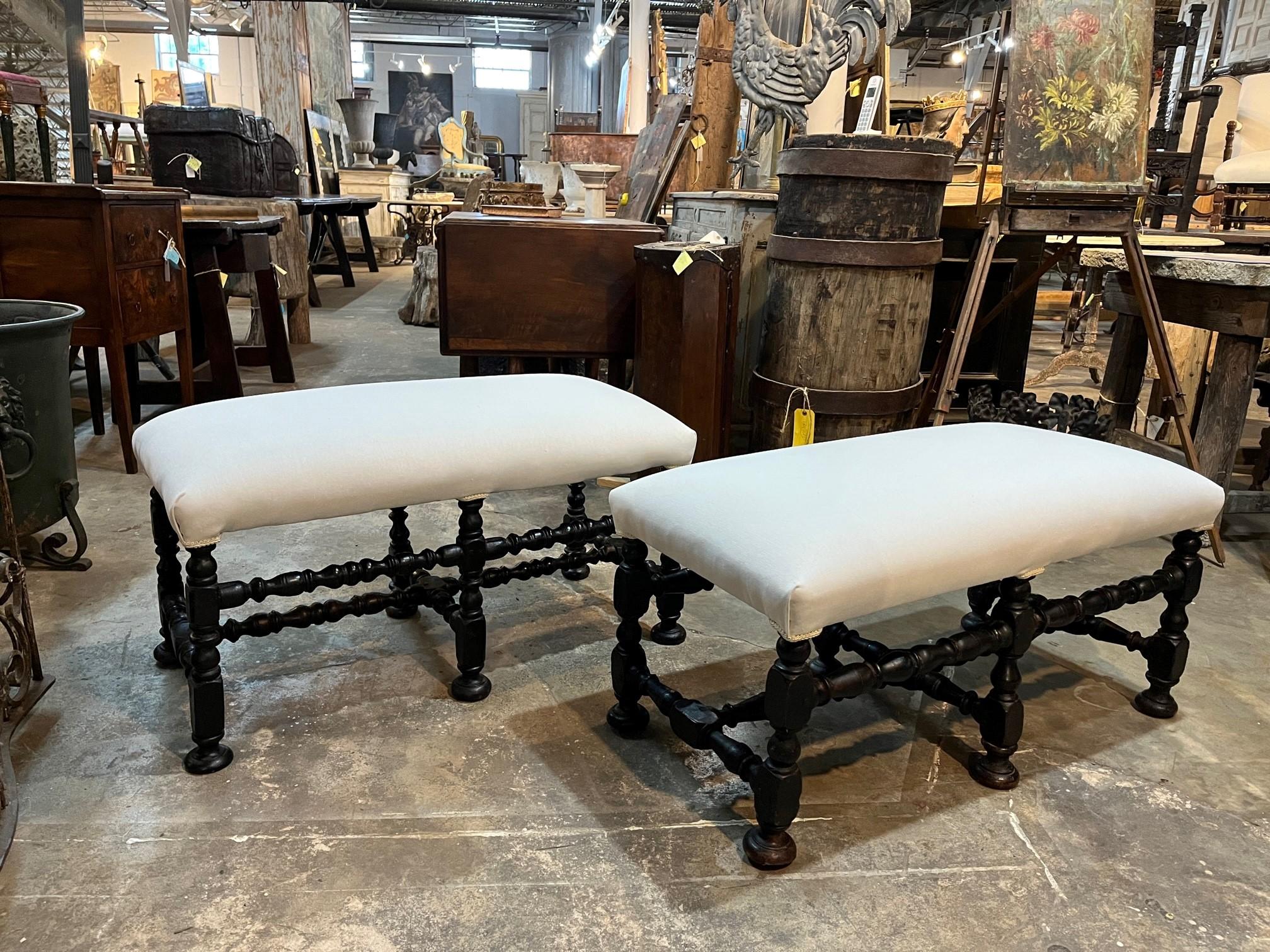 A charming pair of 18th century Benches from the Piedmont region of Italy. Soundly constructed from handsome walnut with beautifully turned legs and stretchers, raised on bun feet. Recently reupholstered.