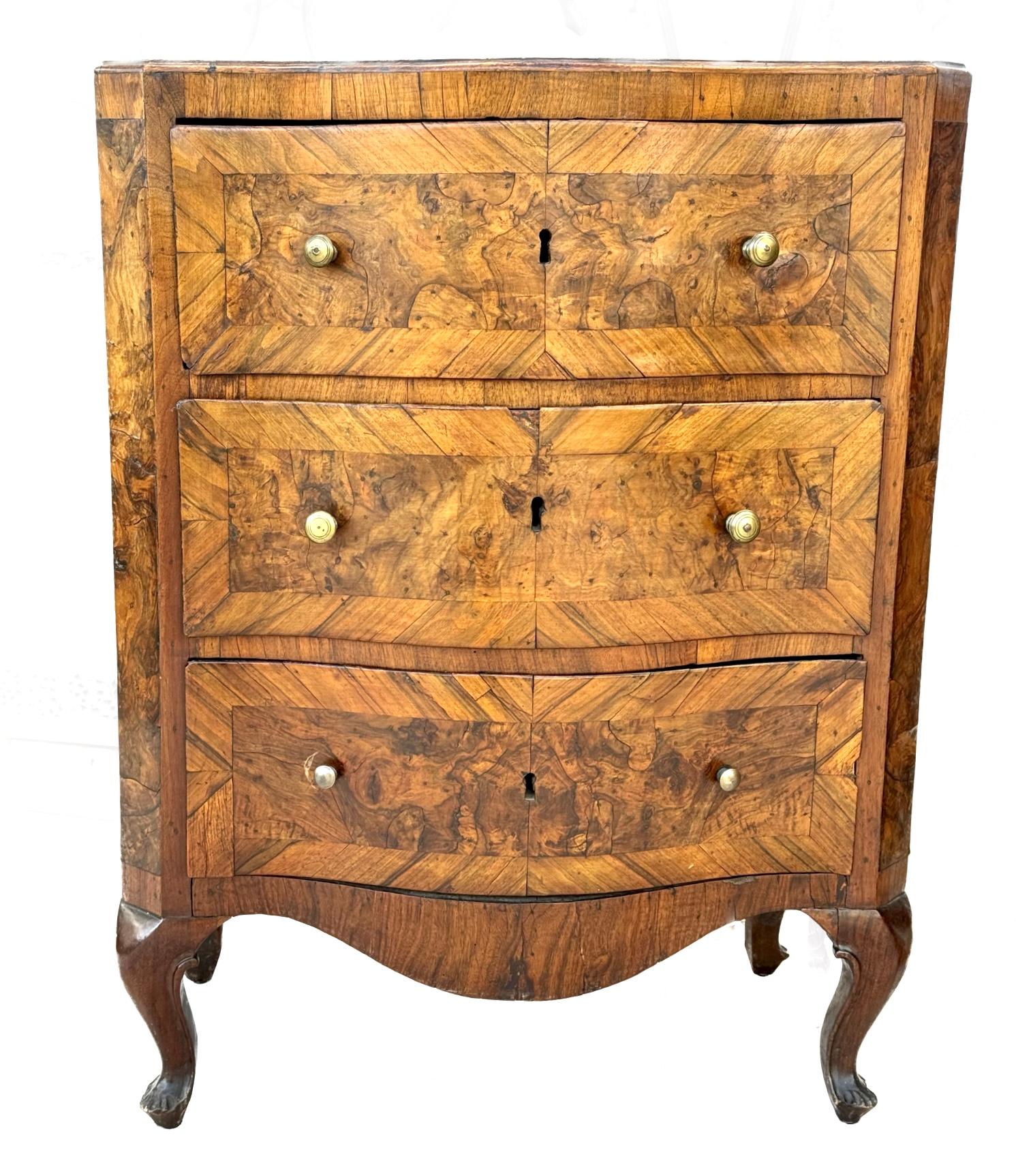 Rare and very fine quality pair of 18th century Italian burl walnut bedside cabinets. One cabinet has three drawers, while other cabinet has a trompe l'oeil front that looks like drawer fronts yet opens as a single door with two shelves inside.