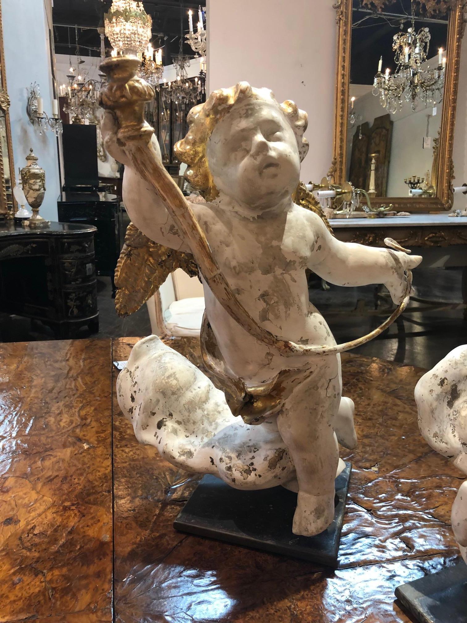 Very impressive 18th century pair of carved and parcel gilt cherubs on steel stands from Italy. Lovely carving and patina on these.