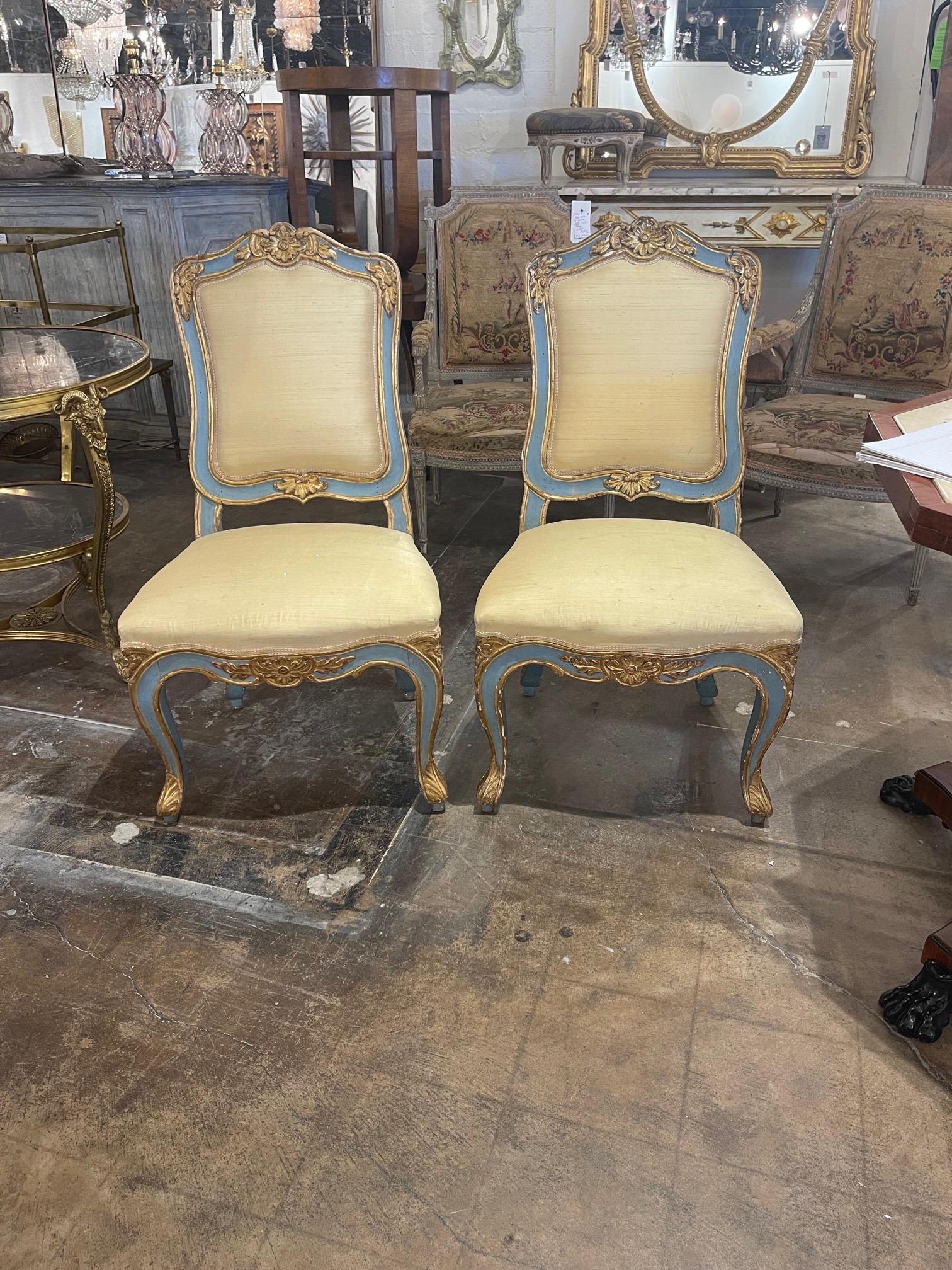 Lovely pair of Italian upholstered parcel gilt side chairs. Pretty carvings and upholstery. A beautiful design element!