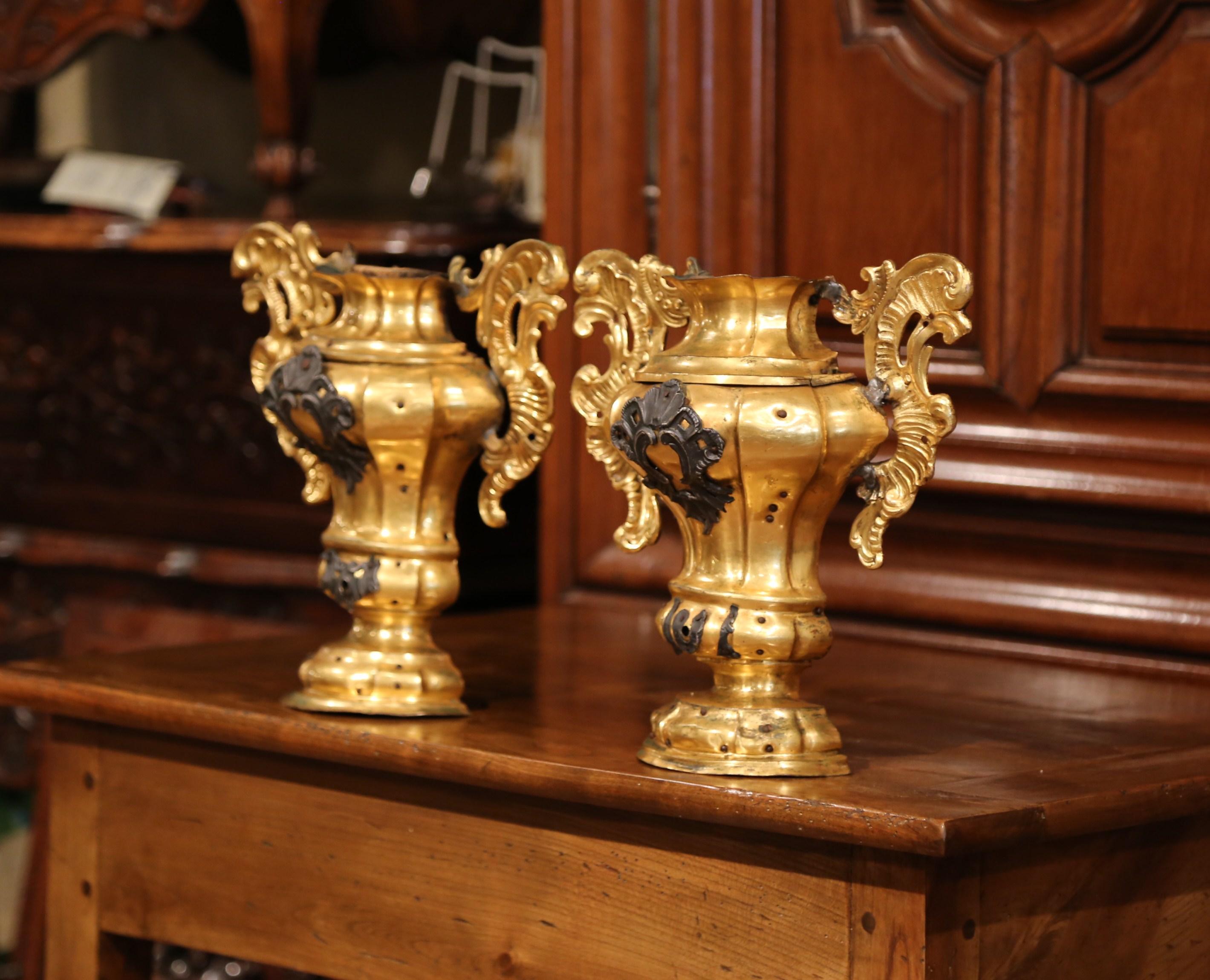 Crafted in Italy, circa 1760 and shape as half vase, each decorative element is hand carved and embellished by a gilt brass covering and decorated with intricate handles. Both ornaments are in excellent condition commensurate with age and use with a