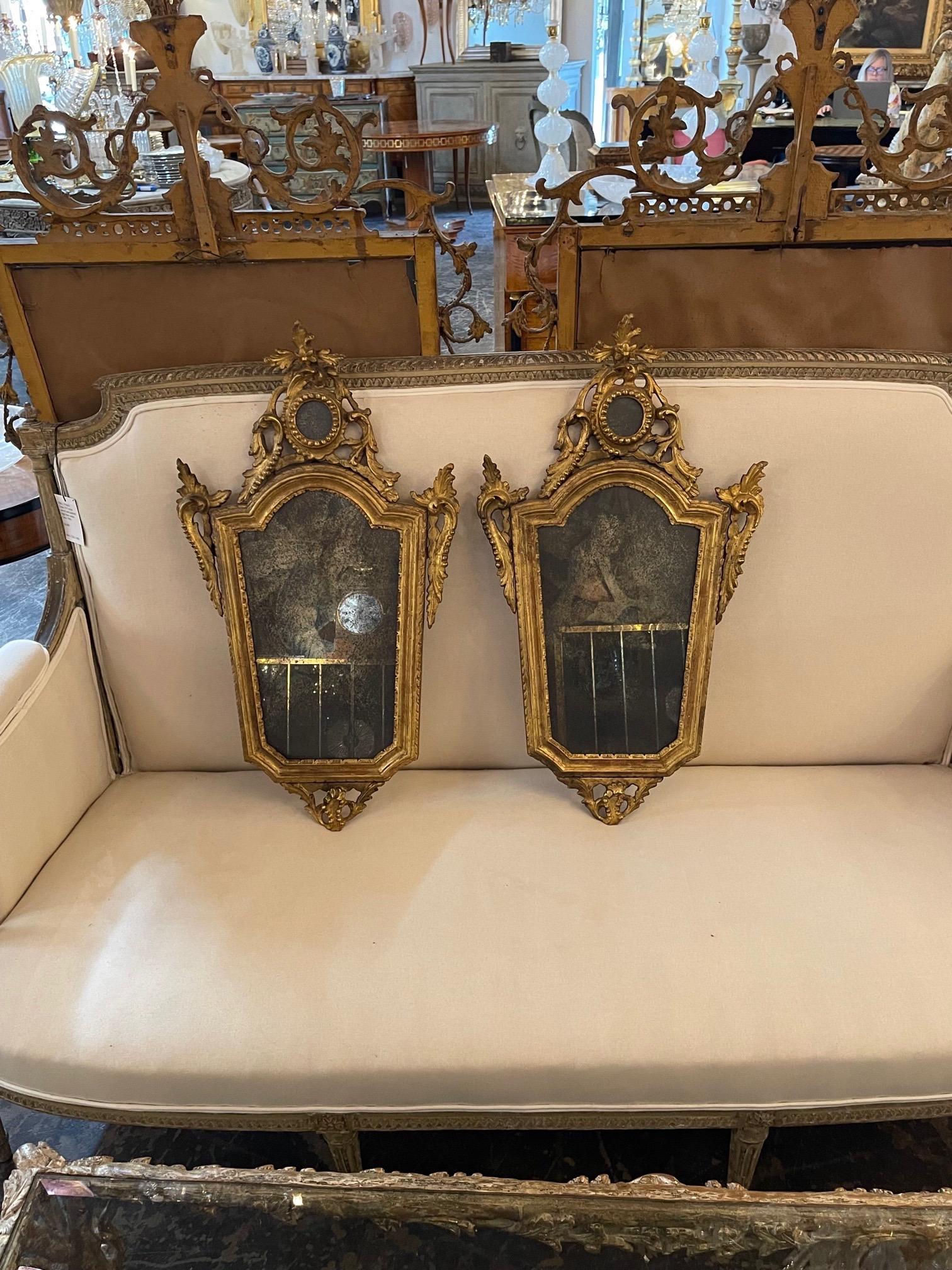 Exquisite pair of 18th century Italian carved giltwood mirrors. Very fine carvings and lovely gilt finish. Very special!