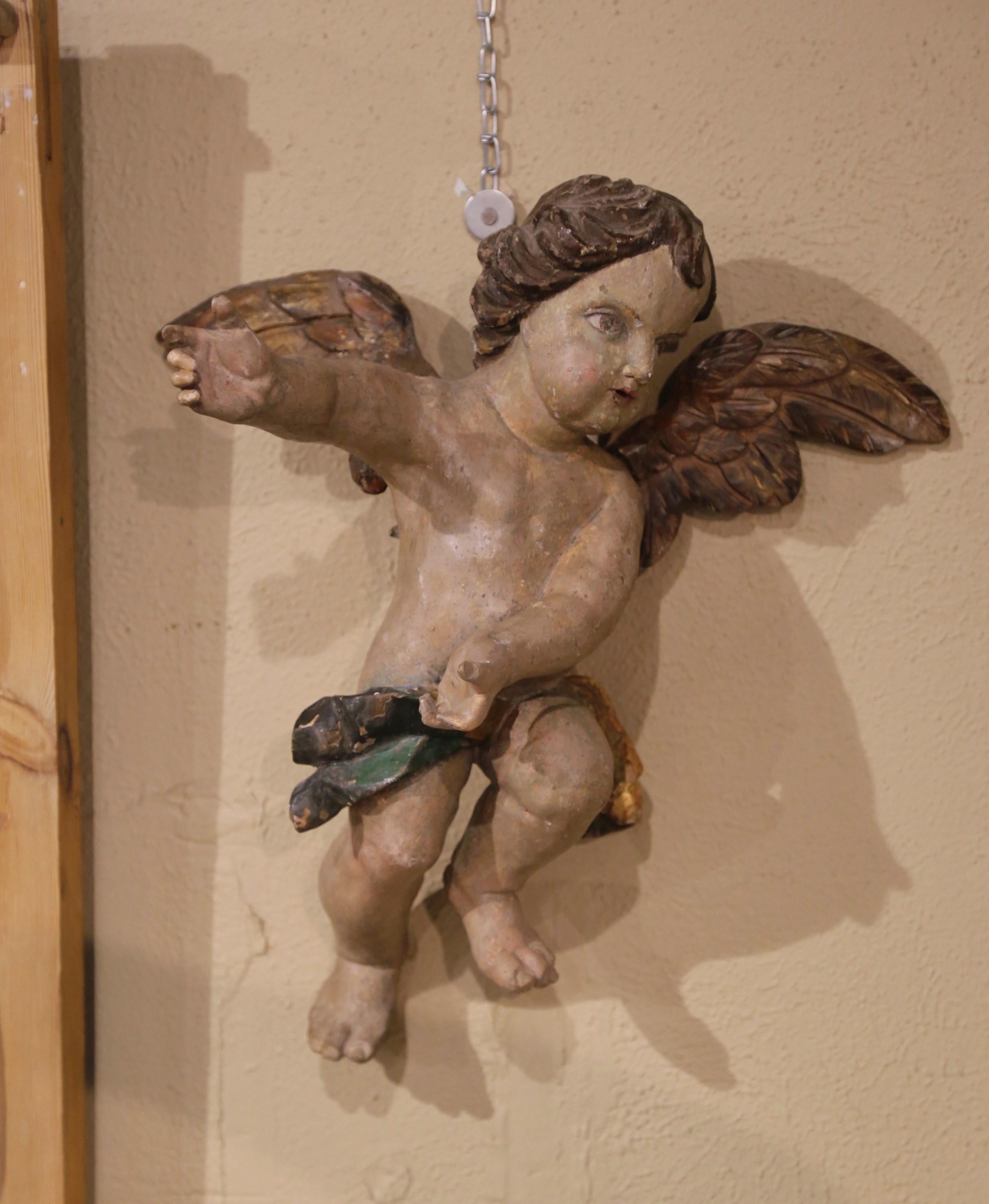 These antique winged cherub figures were crafted in Italy, circa 1780. The hand-painted putti carvings feature their original polychrome, paint and gold leaf finish for a luxurious result. The hand carved chubby cherubs are expressive in their