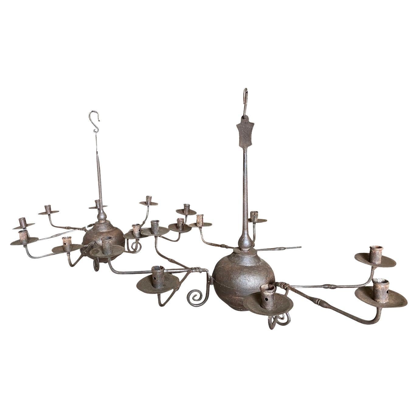 A very handsome pair of 18th century Chandeliers from Udine, Italy.  Wonderfully crafted from beautifully patina'd iron.  Each with 9 lights. The arms are removable.