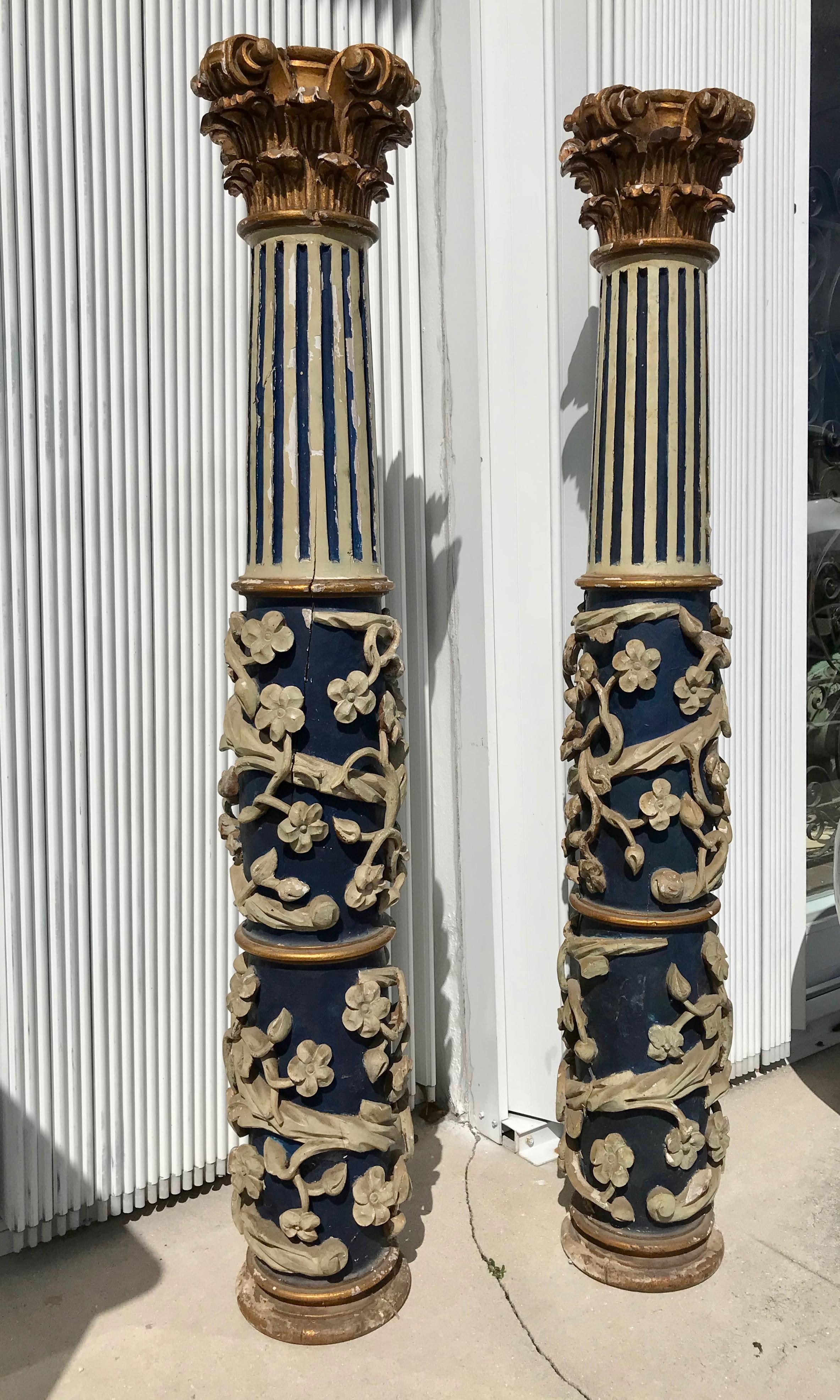 Elaborately carved with a protruding foliated vine surrounding the base of the columns which are reeded at the top and appointed with gilt wood 
capitals. A rare and substantial pair.