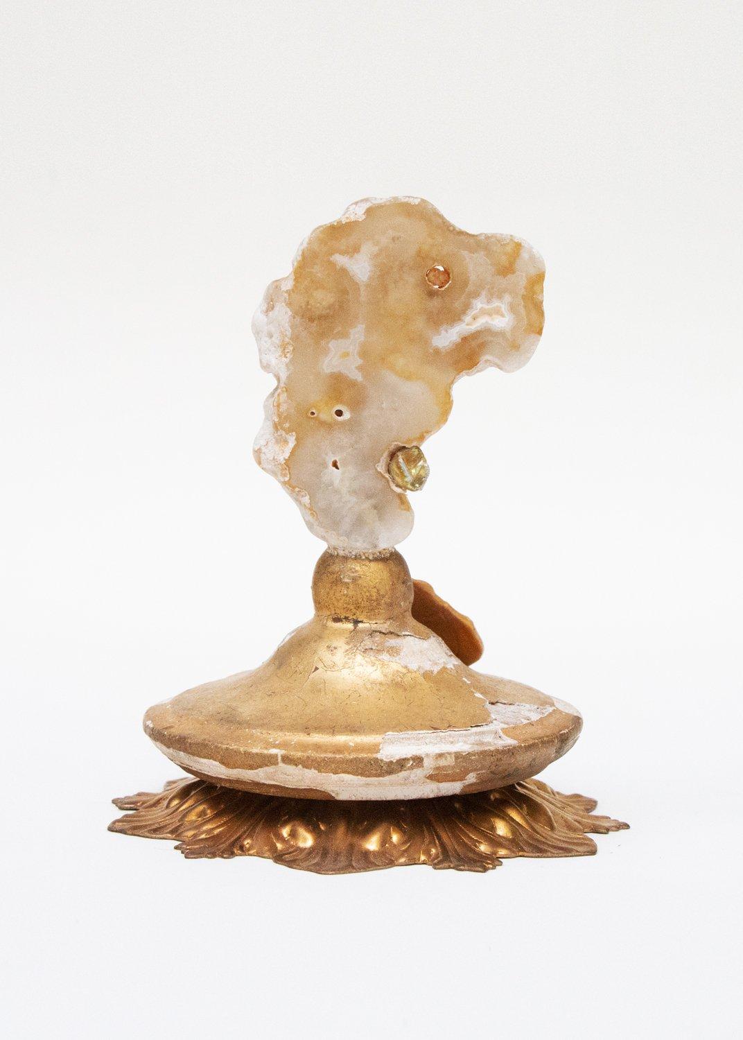 A pair of 18th-century Italian candlestick tops, with polished agate coral and a baroque pearl.

The hand-carved, gold leaf candlestick tops originally came from a pair of candlesticks from a church in Tuscany. They stand on antique metal drip pan