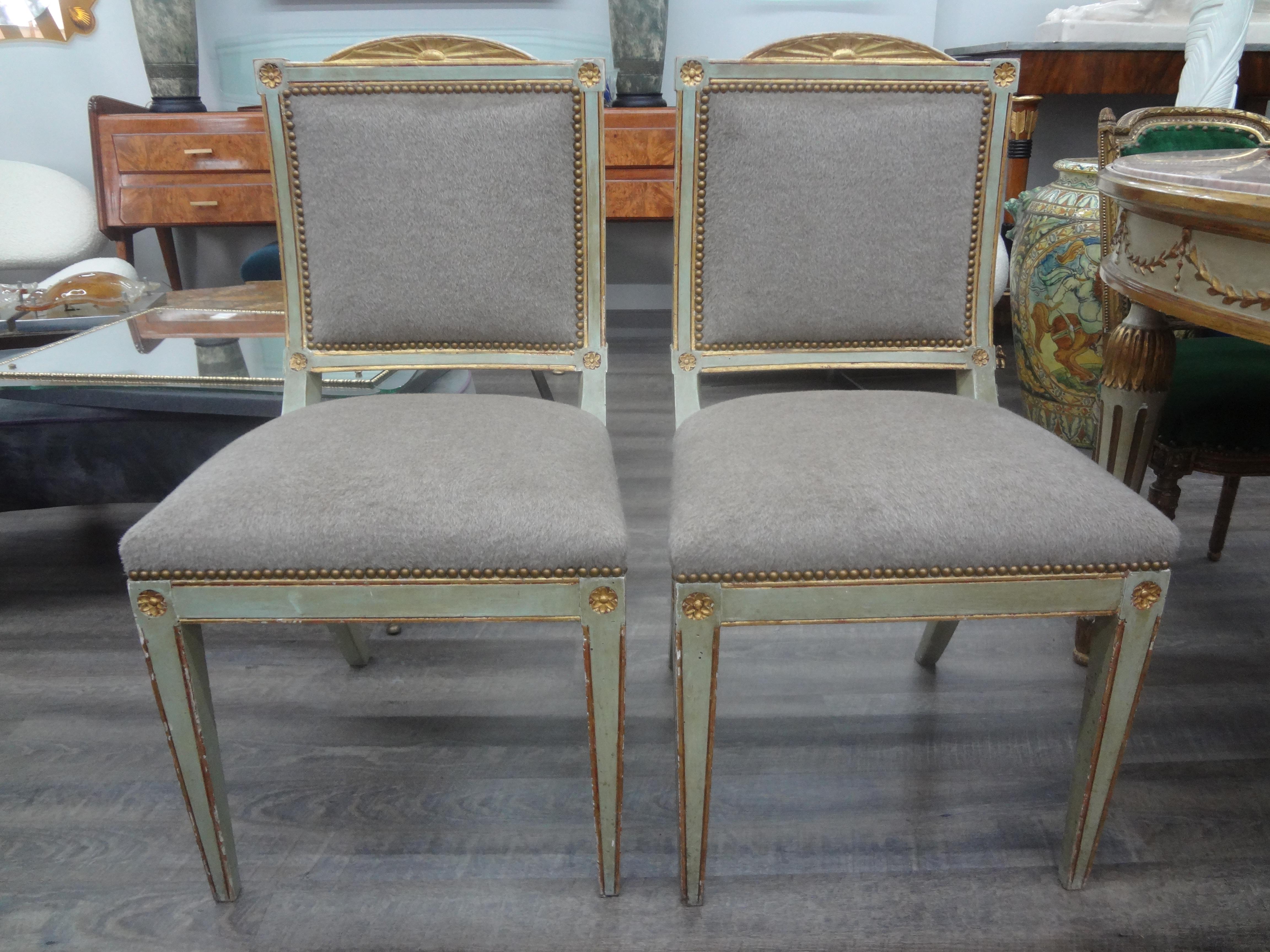 Pair of 18th century Italian Directoire painted and parcel gilt chairs.
This stunning pair of 18th century Italian Directoire chairs are painted a beautiful soft green accented with gilt and have Klismos legs. Our antique Italian side chairs,
