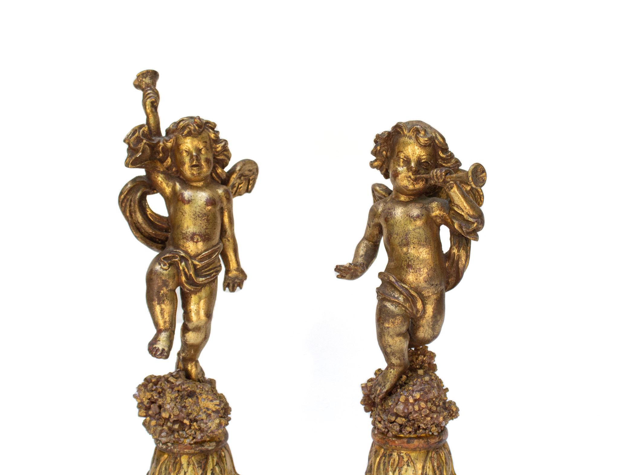 Pair of late 18th century Italian hand-carved, gilded angels with instruments on aragonite clusters with coordinating Italian hand-carved wood fragment bases.

The carved angels and bases are originally from a church in Tuscany and have been