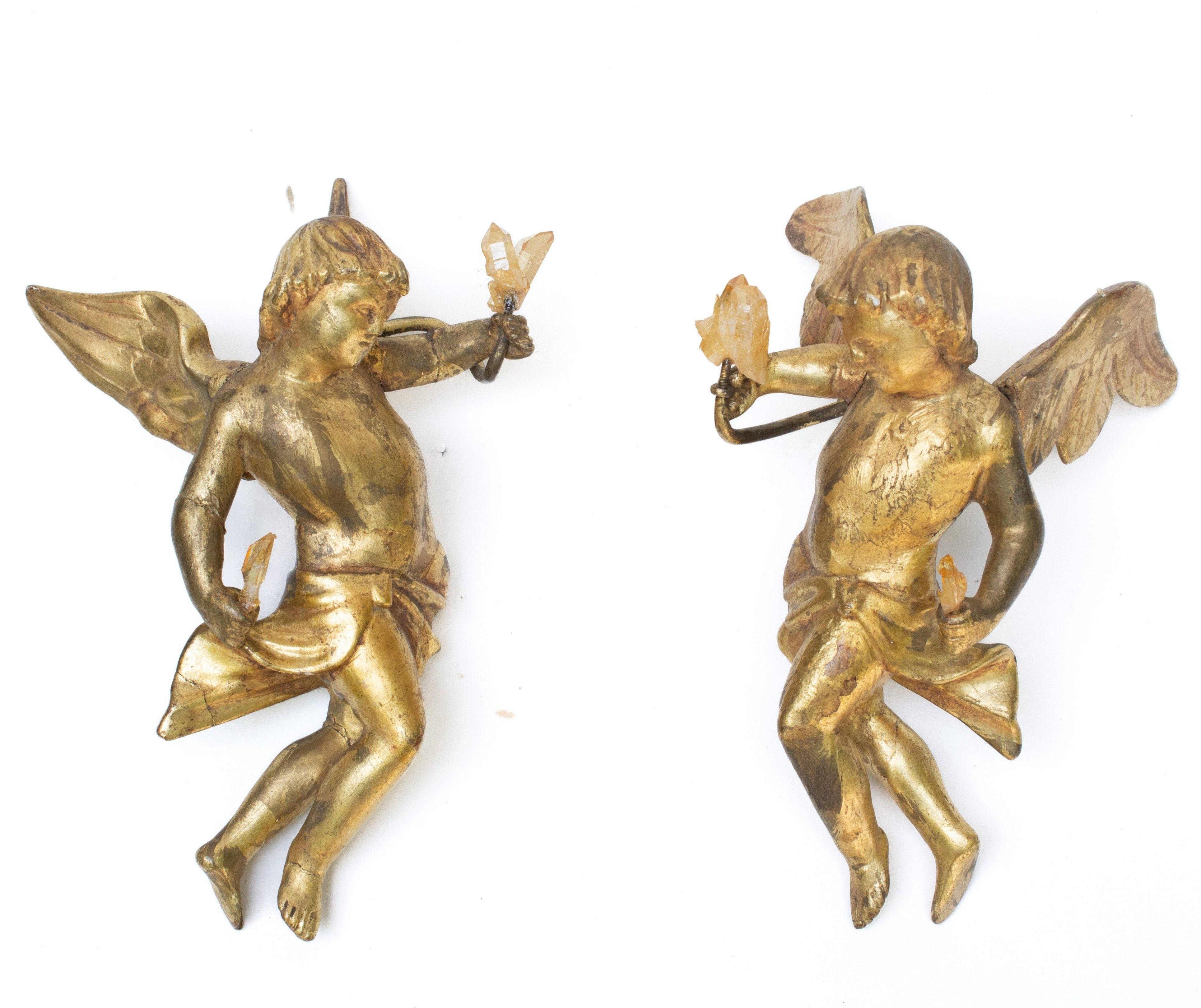 Pair of 18th century Italian hand-carved gold leaf angels with golden quartz crystals. The sculptural pair have the original metal wall hangers to be hung on the wall. The hand-carved angels were once part of a heavenly, angelic depiction or