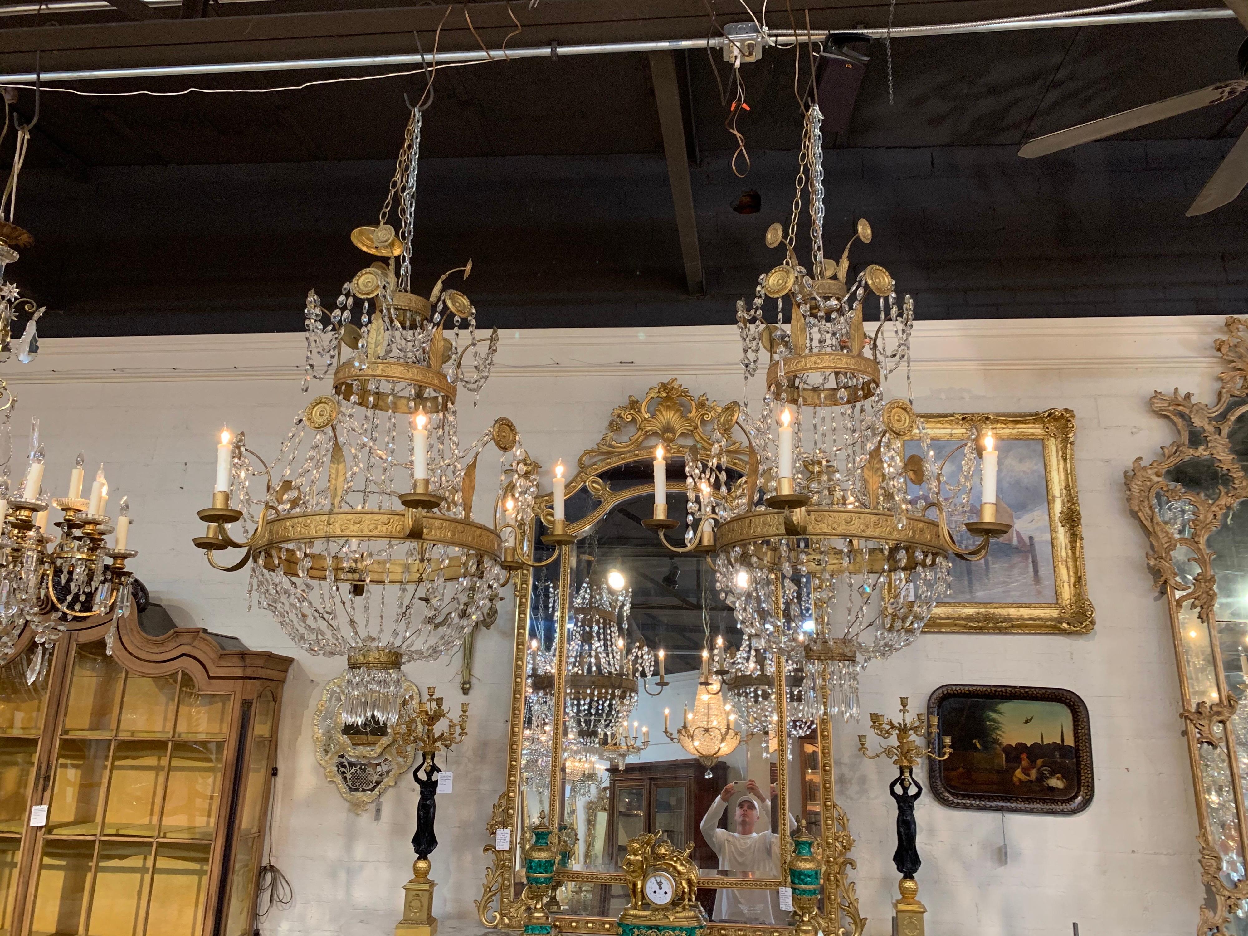 Exceptional pair of the 18th century Italian gilt metal beaded and crystal chandeliers from Tuscany. Featuring beautiful floral design on the gilt and shimmering crystals. Outstanding!