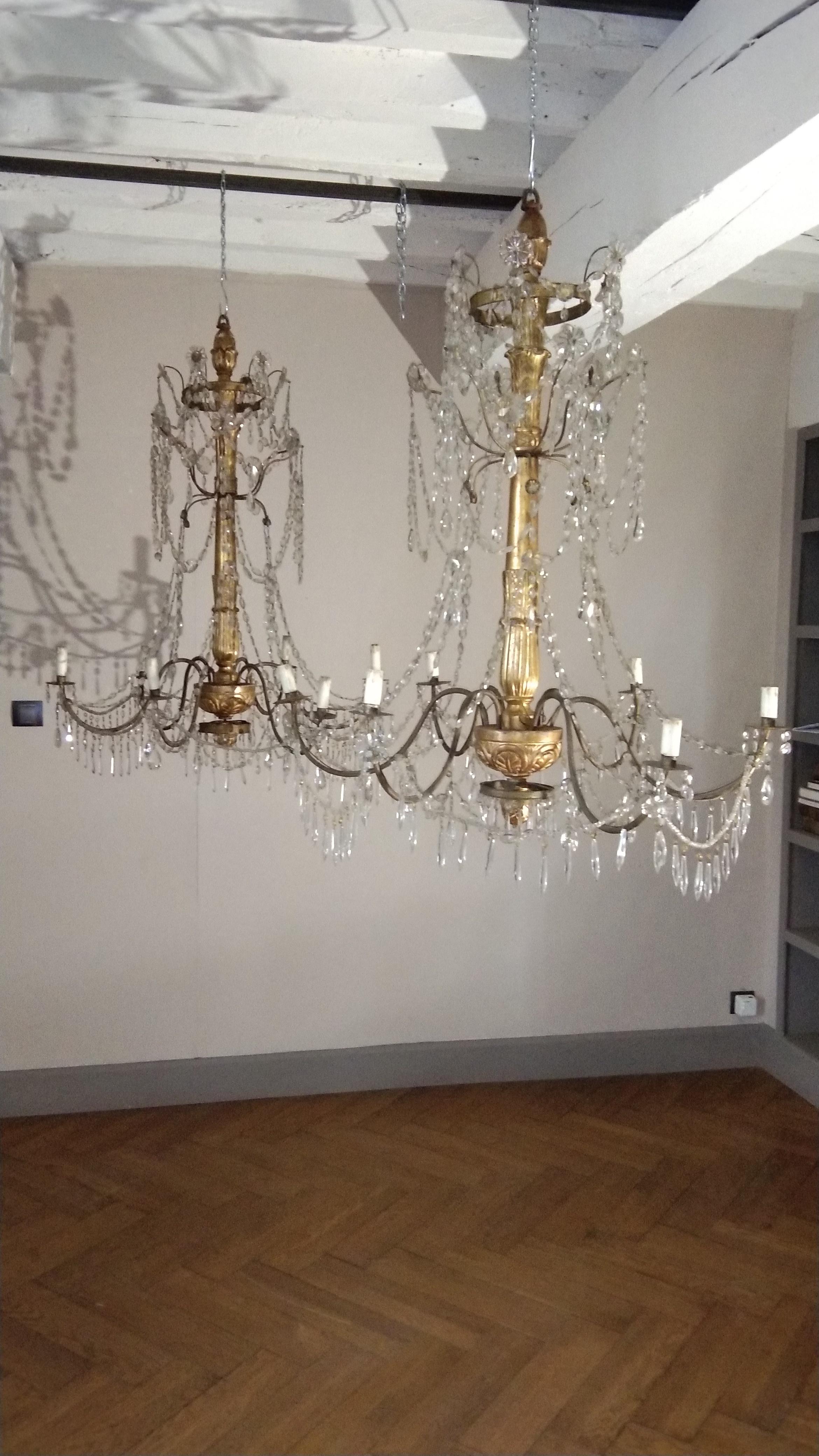 Pair of 18th century Italian giltwood and beaded crystal chandeliers from Italy

A pair of late 18th century wooden carved and giltwood chandeliers composed of six arms with original gilt. Originally candle powered and have been electrified to