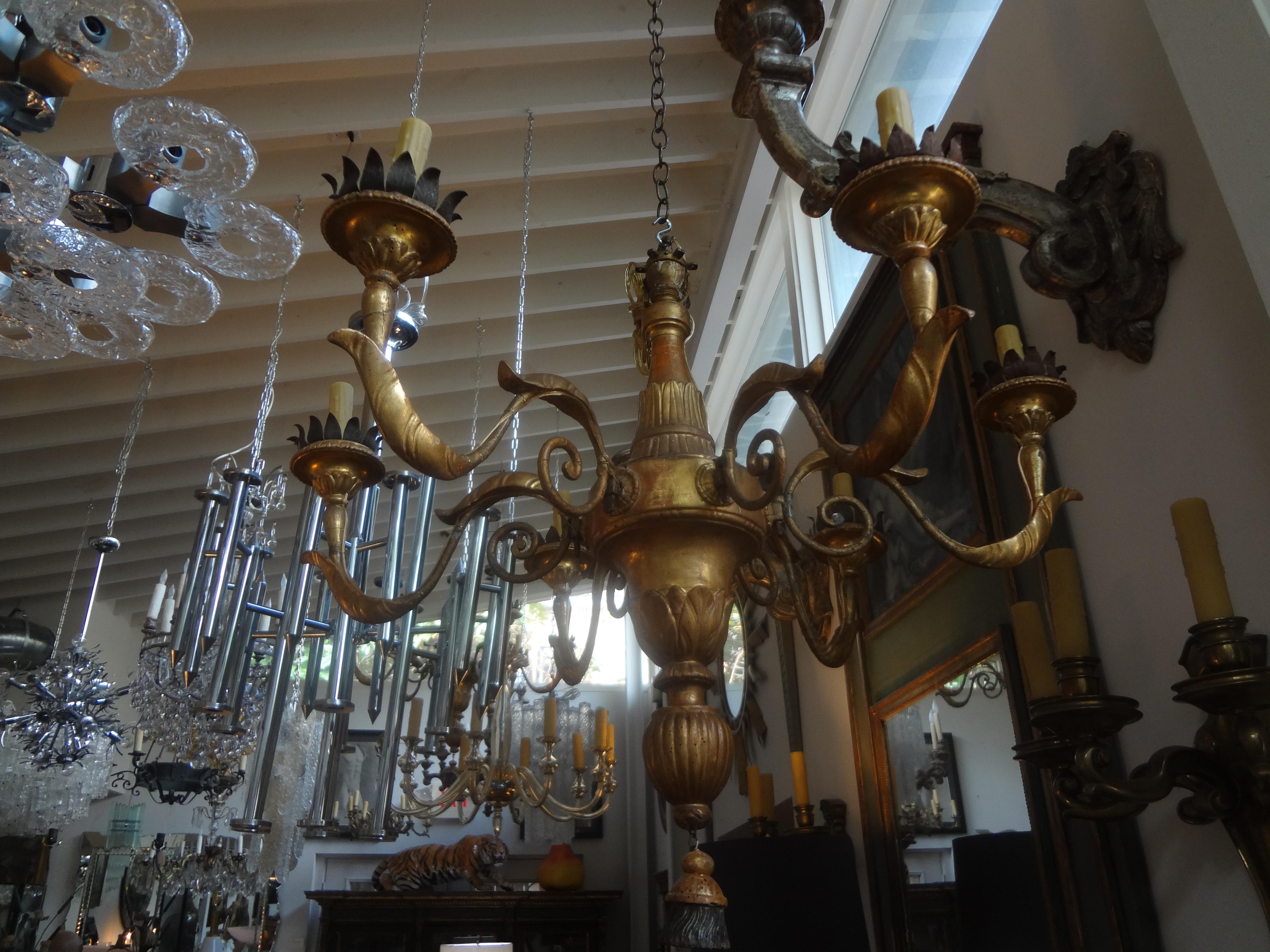 Rare find!!!
Magnificent pair of 18th century Italian giltwood chandeliers from Tuscany. These fabulous 18th century Tuscan Louis XVI six arm giltwood chandeliers have been newly wired with new sockets for the American market.
Height can be