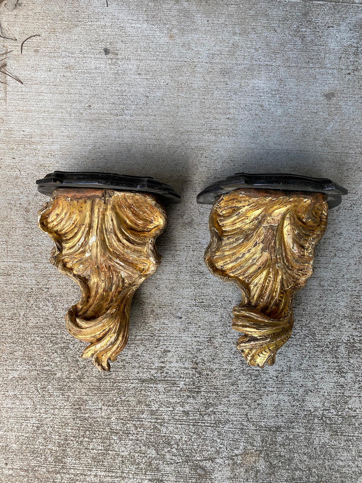Pair of 18th century Italian giltwood shell brackets with marble tops.