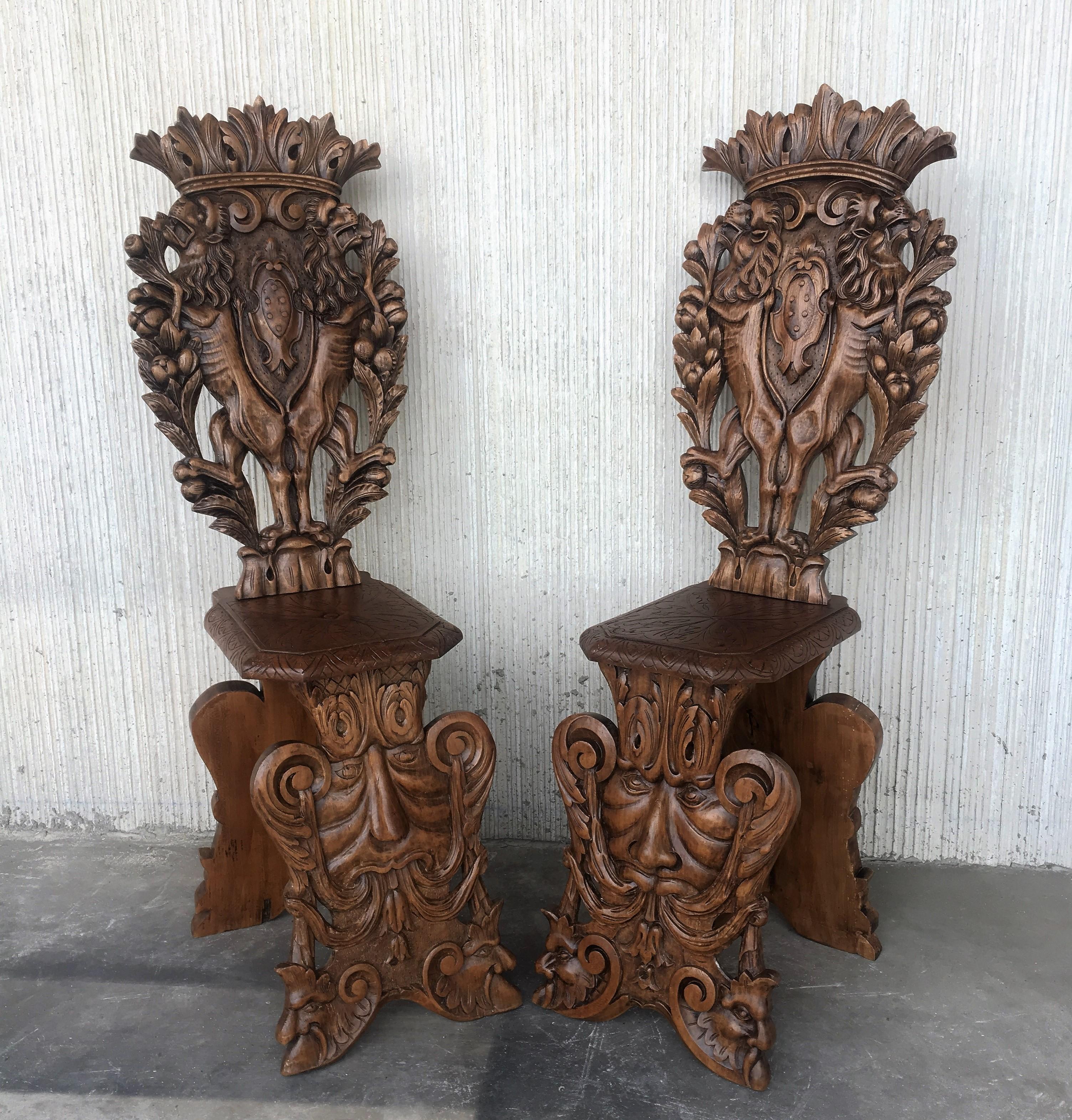 Pair of 18th century Italian Renaissance lion carved walnut Sgabello hall chairs.

Pair of Flemish carved oak hall chairs, circa 1890.
Profusely carved with heads, swags and foliage.

Pair of antique Italy 