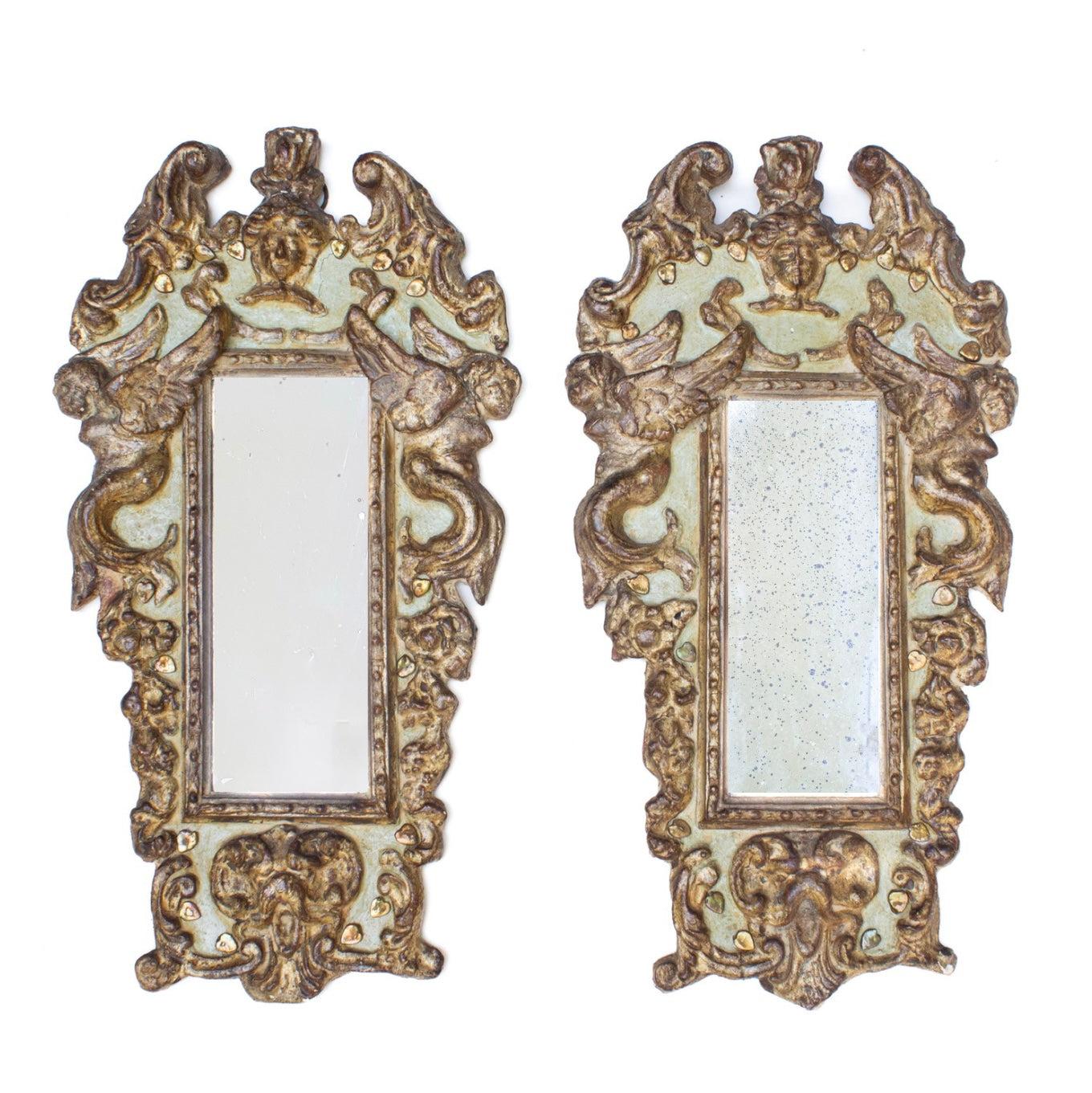 Pair of 18th century Italian green and gilded cherub mirrors. The mirrors have been hand-carved and molded with each cherub unique unto itself. The mirrors are originally from Florence, Italy and are adorned with heart-shaped baroque pearls that