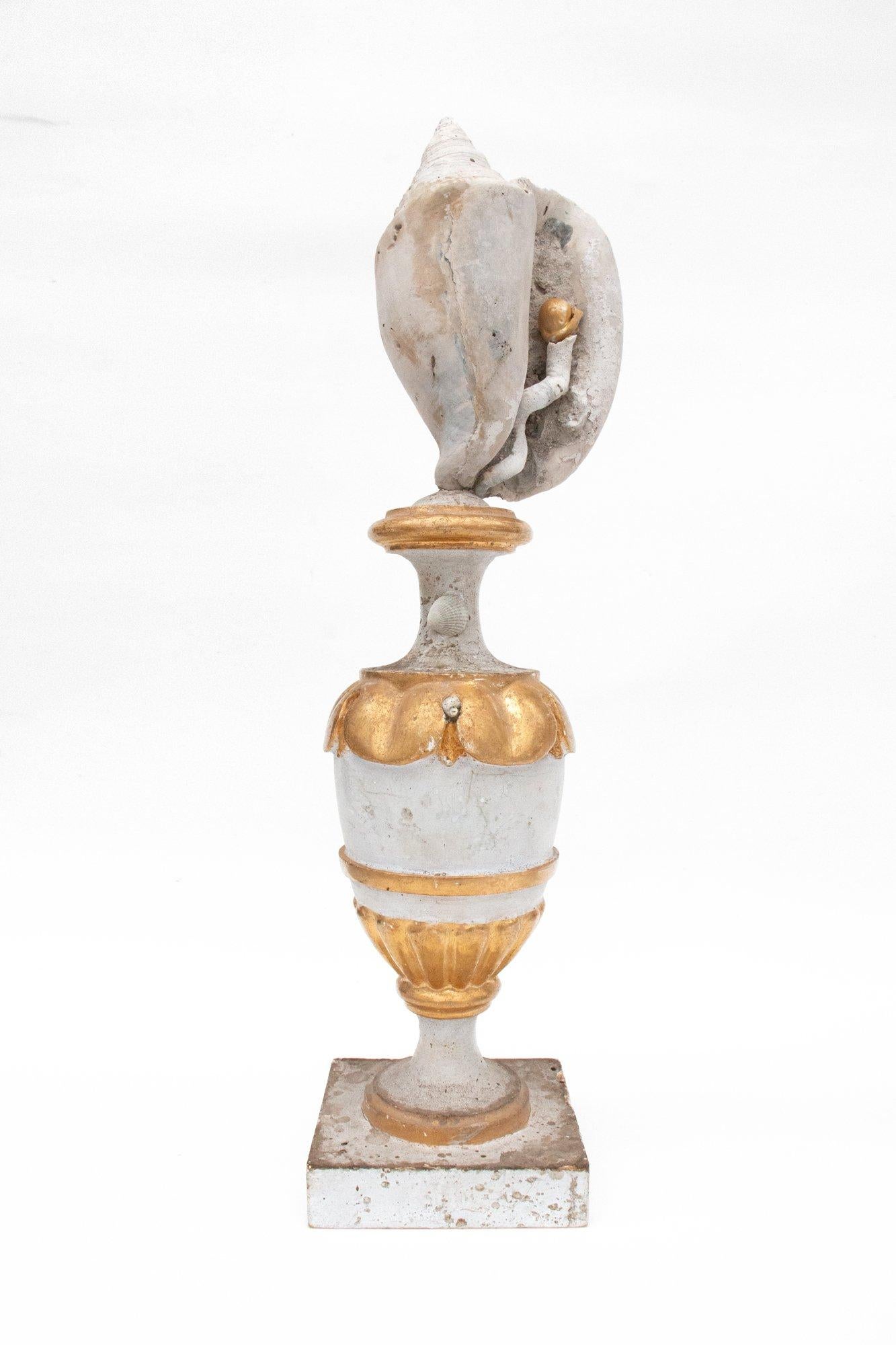 A pair of 18th century Italian gold leaf church altar vases decorated with fossil shells, siliquaria, and natural forming baroque pearls. The vases originally came from a church in Arezzo, Italy. They are hand-carved and hand-painted by nuns in a