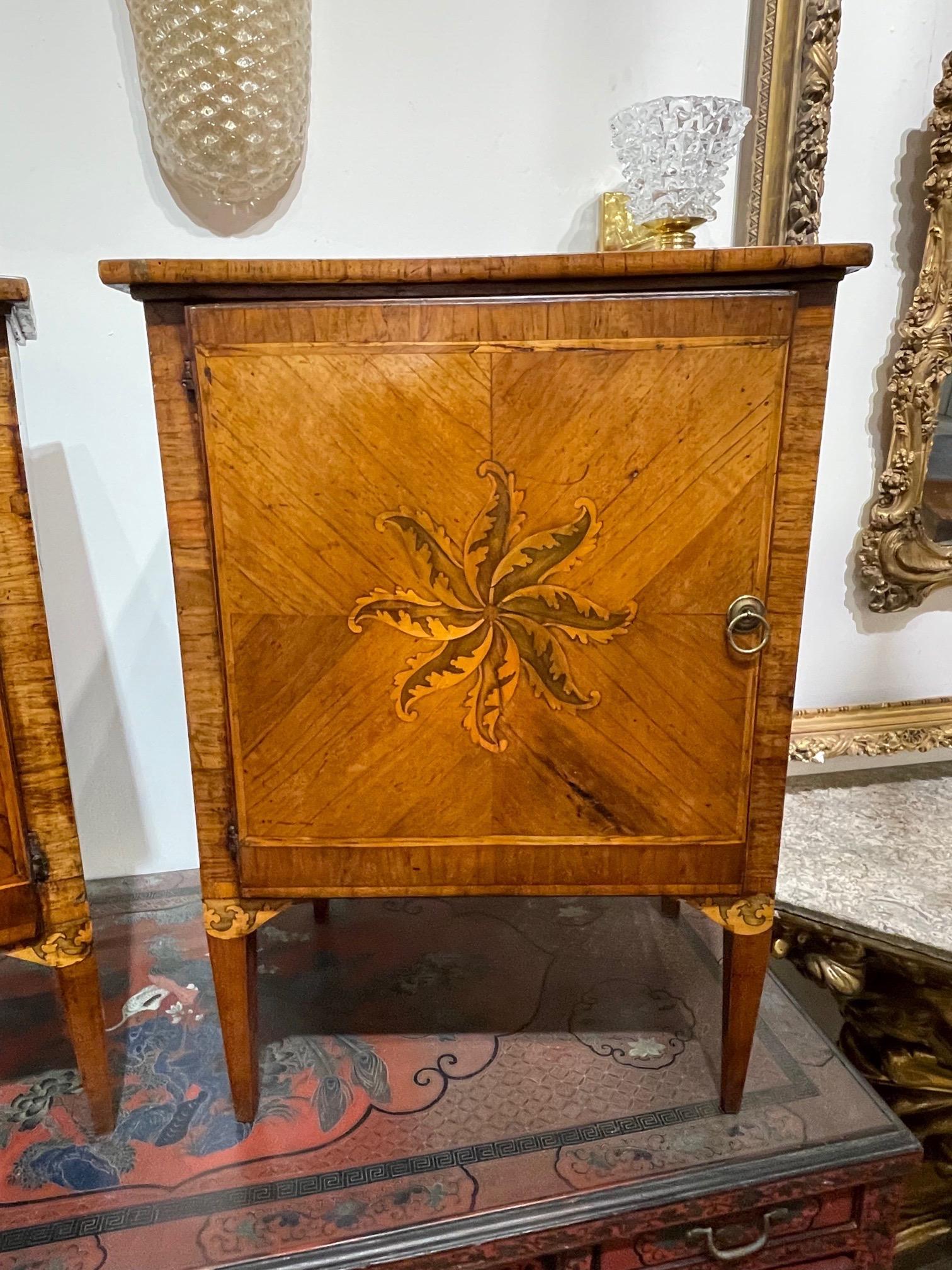 Lovely pair of 18th century Italian and mahogany inlaid commodes. Featuring a beautiful decorative pattern on the front of the cabinets. Just gorgeous!!.
