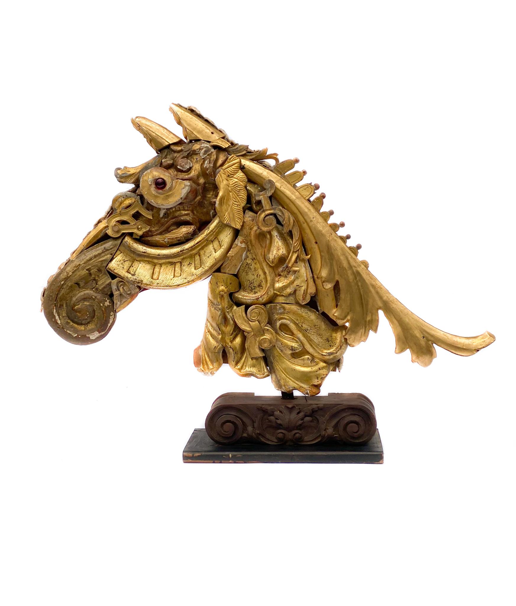 Pair of 18th century Italian gold-leaf fragment horse head sculptures.

The pair is made of 18th century Italian water-gilt fragments mounted on scroll wood bases. The fragments come from historic churches, buildings, and pieces from Tuscany. The