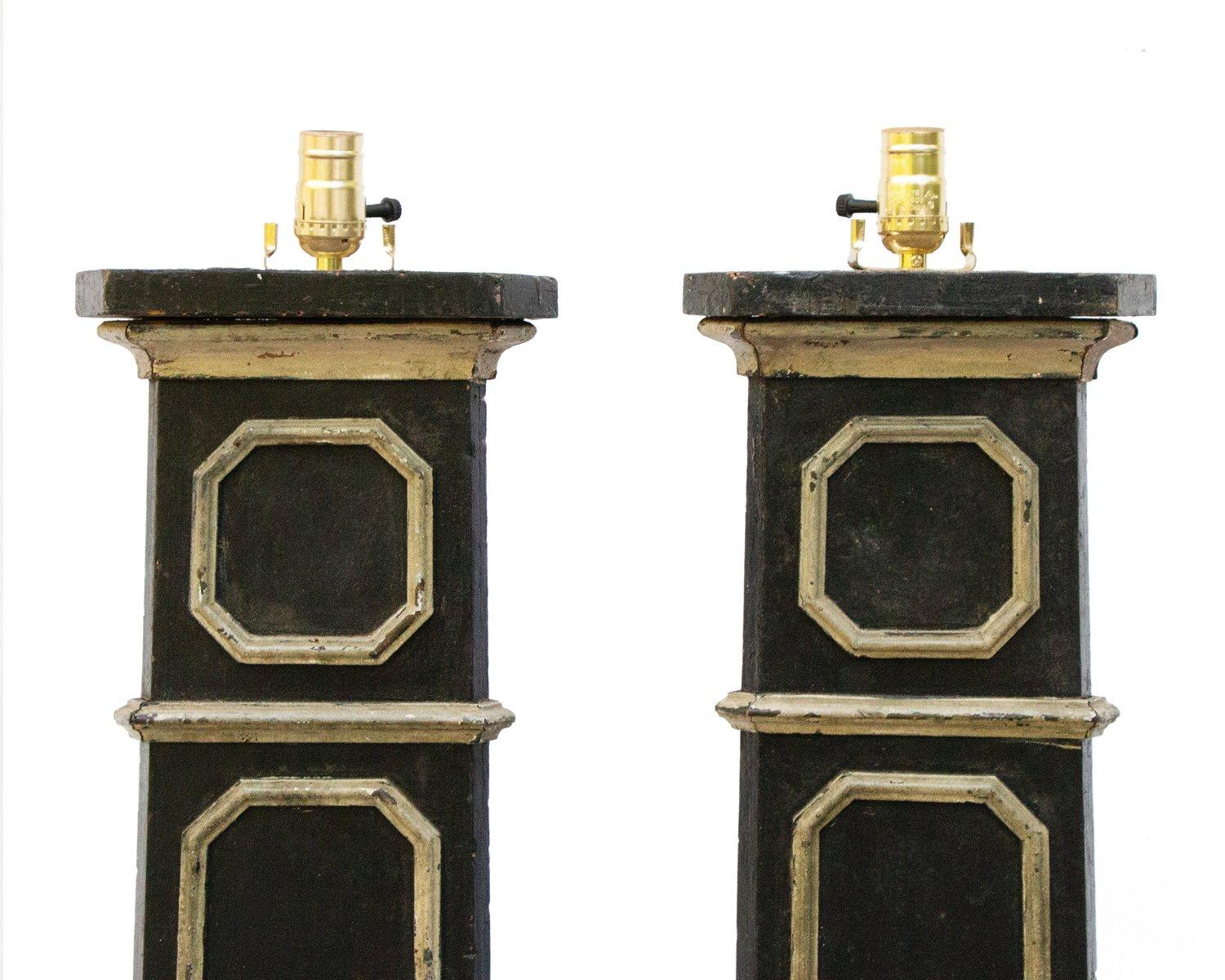 A pair of 18th century Italian wooden black floor lamps with hand-carved crescent moons decorating the body of the lamps. These originate from a church in Liguria, Italy. They were originally altar sticks that have been converted into lamps. They