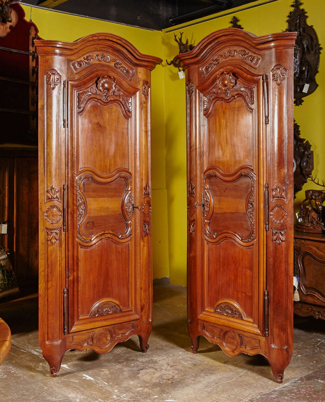 Dress up two corners walls in a living room or dining room with this elegant pair of antique fruitwood cabinets. Crafted in Lyon, France, using both doors of an 