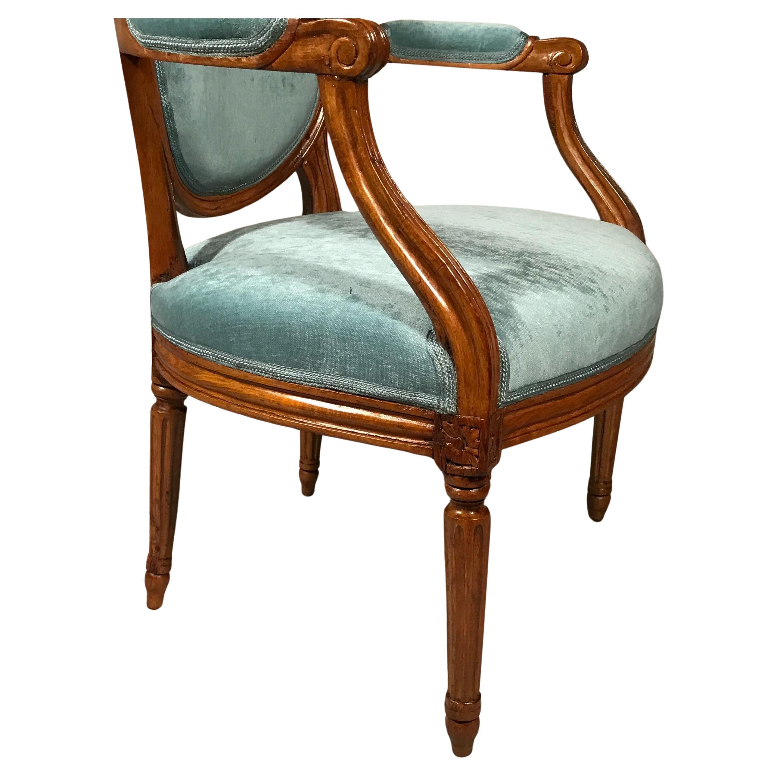 Discover a stunning pair of 18th century French Provincial Louis XVI armchairs featuring elegant oval-shaped backs. These exquisite armchairs showcase the timeless beauty of Louis XVI design, complemented by new upholstery in luxurious light blue