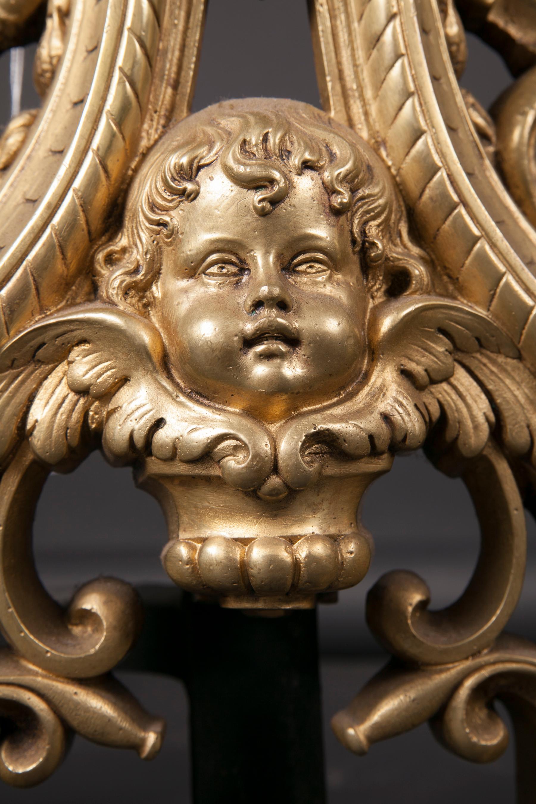 Pair of 18th Century Louis XVI Bronze Chenets with Fleur De Lis, Putti, and Drag In Good Condition For Sale In New Orleans, LA