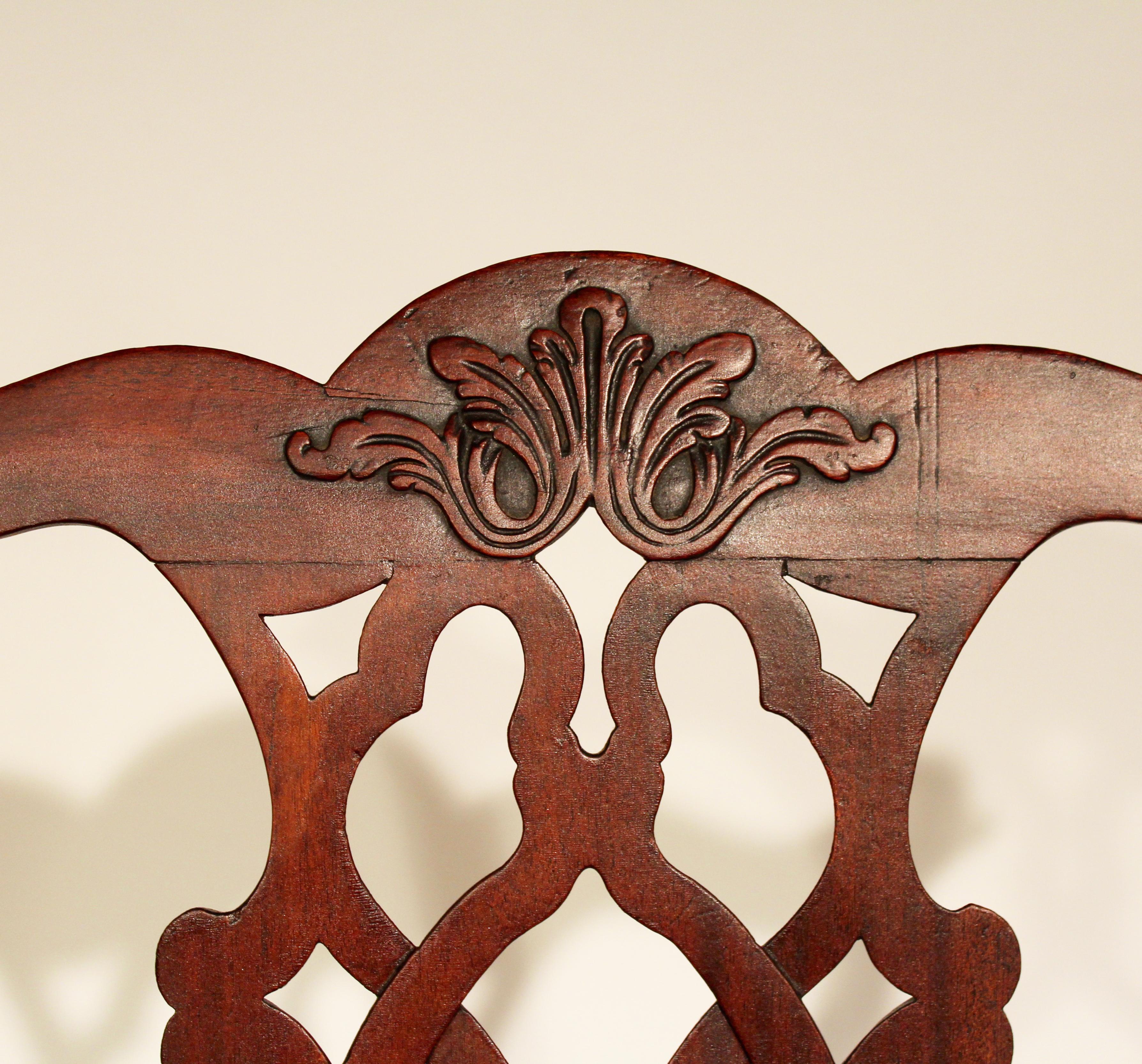 Pair of 18th century Chippendale side chairs possibly made in Maryland with a relief carved crest rail a Gothic carved splat cabriole legs with shells on the knees and terminating in claw and ball feet.