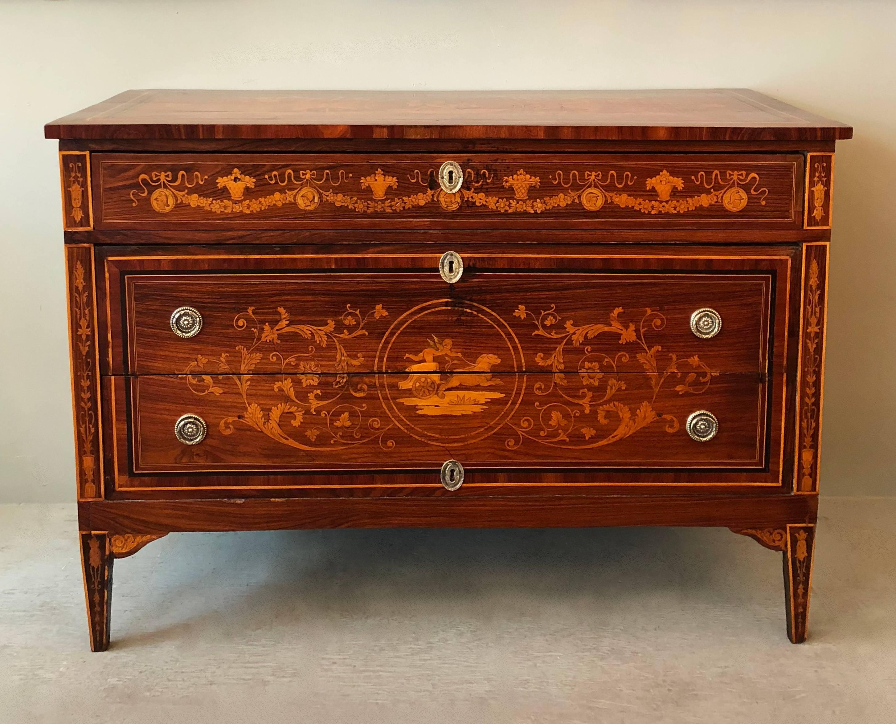 An exceptional pair of rosewood marquetry commodes. Having rectangular rosewood tops framed in seven cross-banded and inlay boarders. The center of the tops have Classical Mythological medallions depicting 