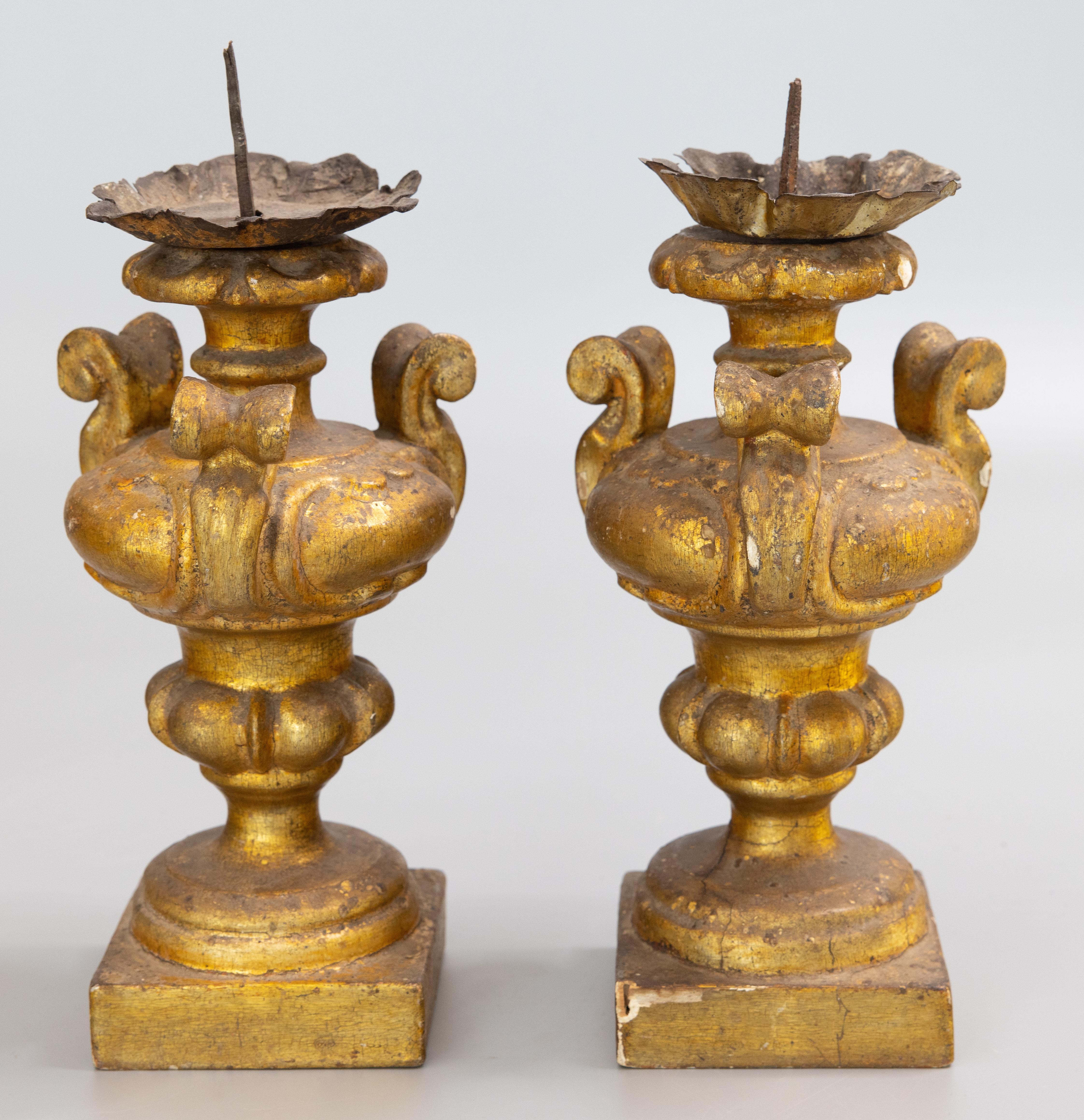 A stunning petite pair of 18th-Century Italian Neoclassical carved gilt wood gold leaf pricket candlesticks with metal bobeches. They measure 10