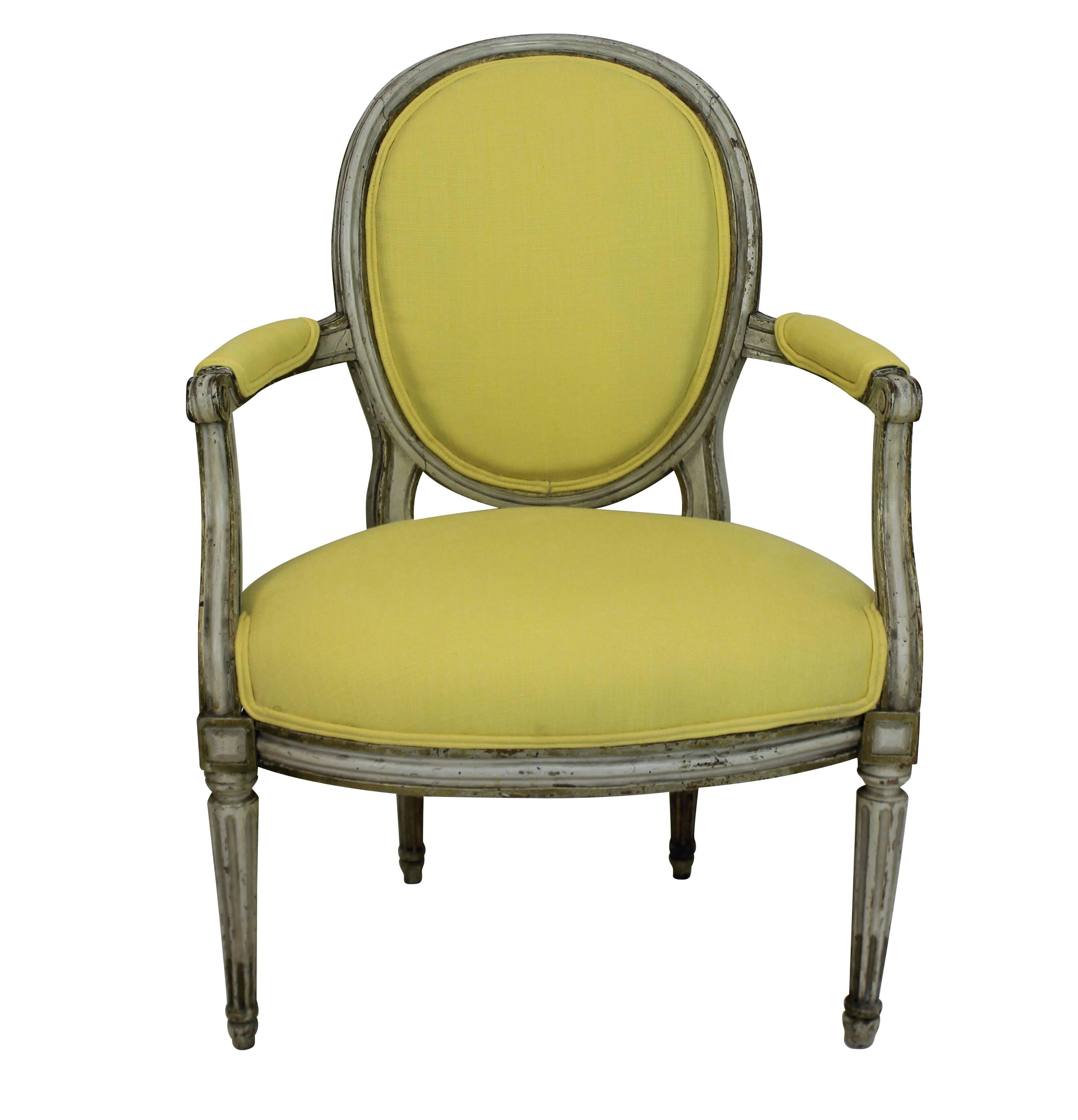 A pair of French 18th century painted armchairs. In their original condition, newly upholstered in Pierre Frey lemon linen.