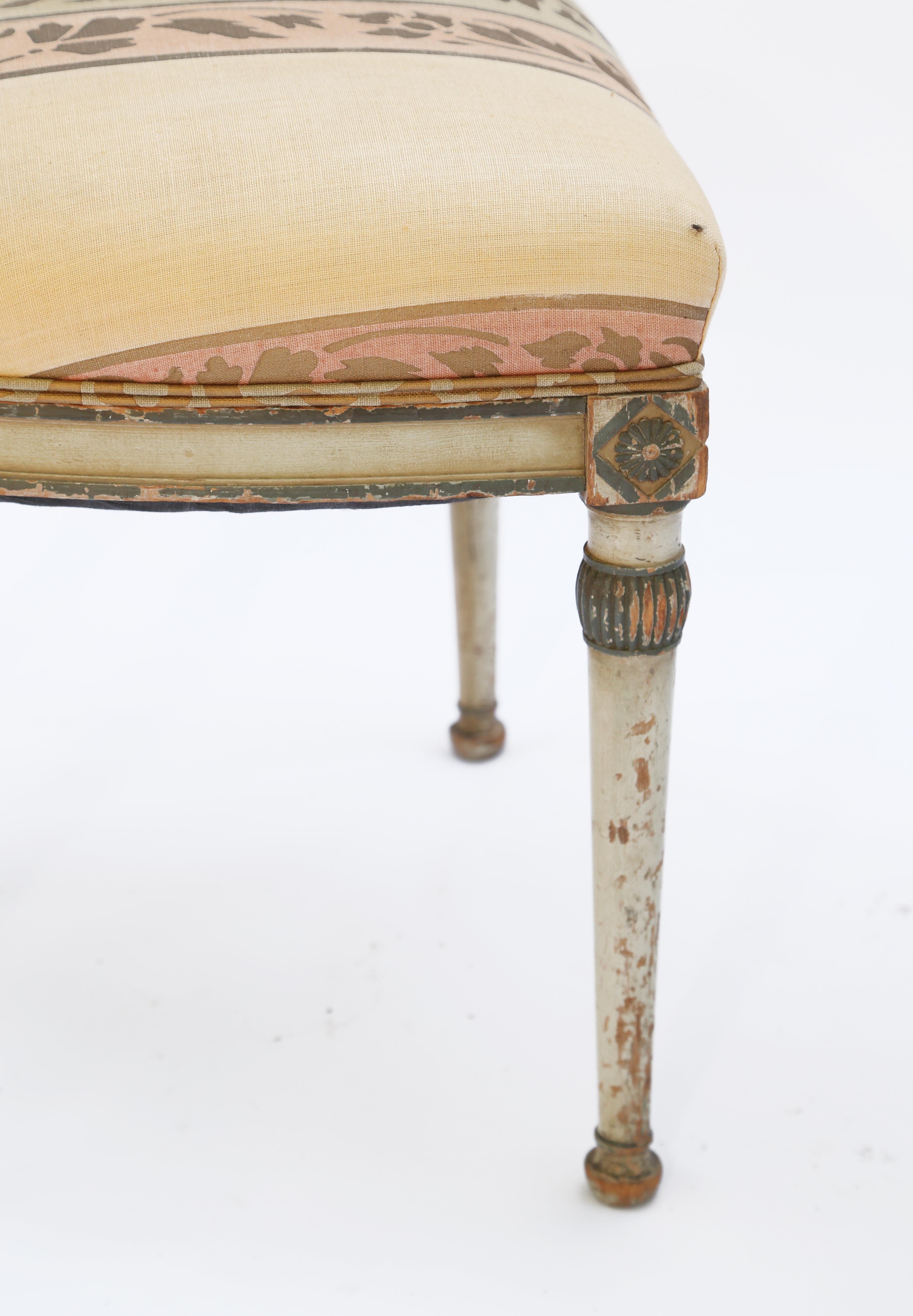 Pair of early side chairs, having a polychromed finish, showing natural wear, each with a molded back, decorated with an urn, on fielded stiles, over crown seat, raised on round, tapering legs.

Stock ID: 1755.