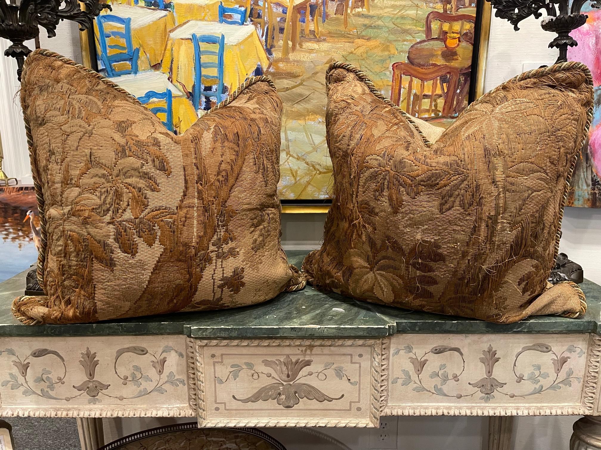 Pair of 18th century Pillows made from an 18th century tapestry fragment depicting trees, leaves, and beautiful flowers. Pillows are backed with chenille, feather down fill, invisible zippers, and decorated with Silk Trim.