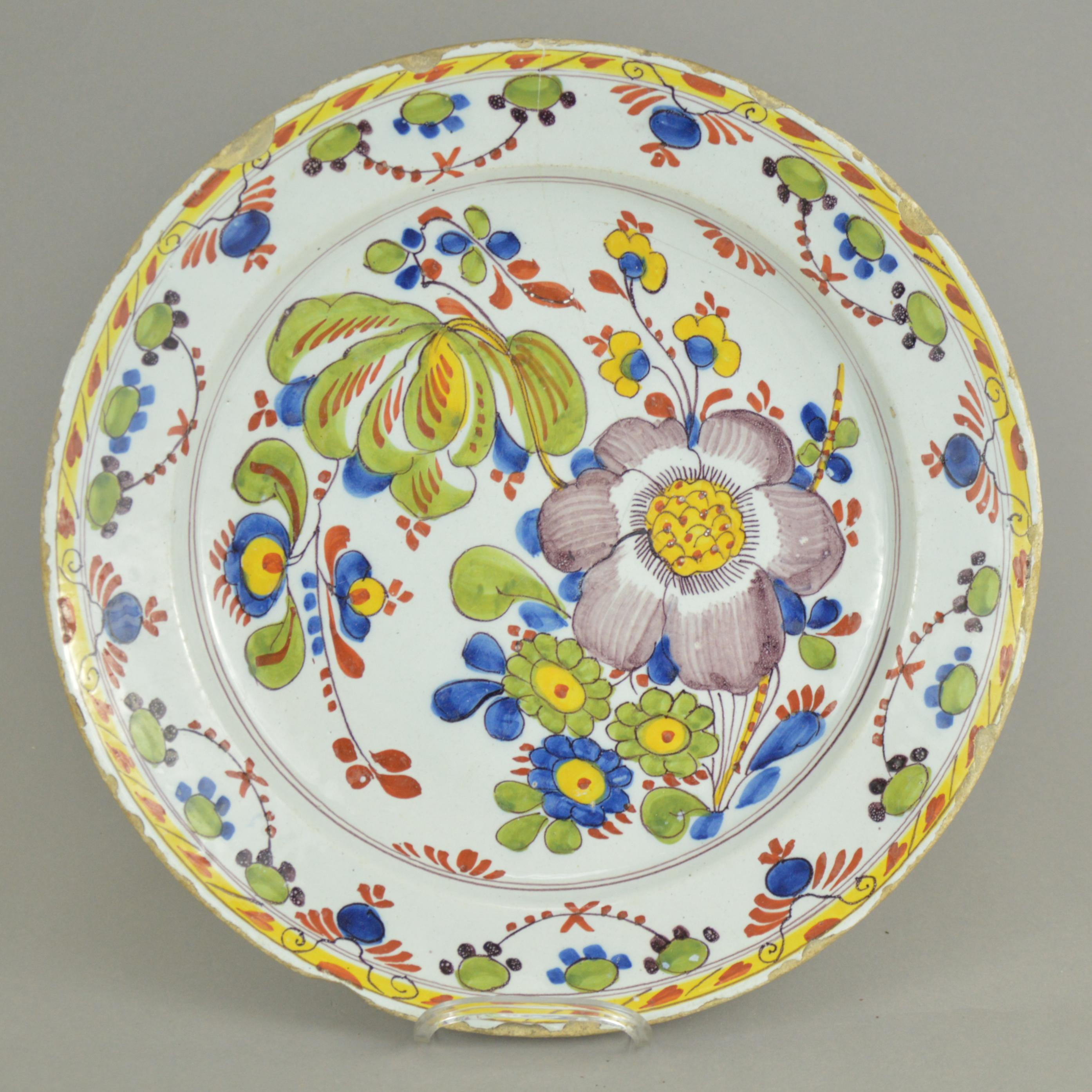 Pair of large decorative polychrome Delft faience plates. Central part of each is richly decorated with flowers.
Measure: Diameter - 35 cm.
Condition report: some chips on the rims, one plate has a crack.