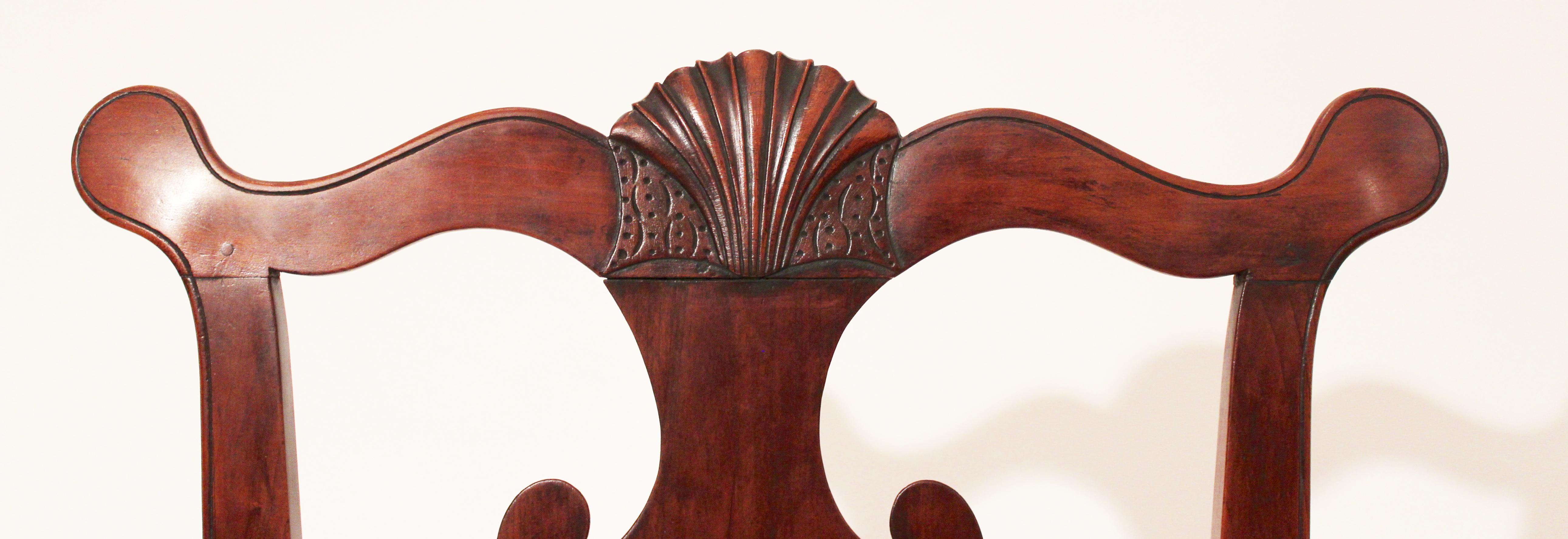 Rare pair of walnut Queen Anne side chairs with carved shell on cupids bow crest rail solid splat a shell carved on front rail and tulip style carving on the knees cabriole legs terminating in trifid feet. Made in Bucks or Montgomery County PA.