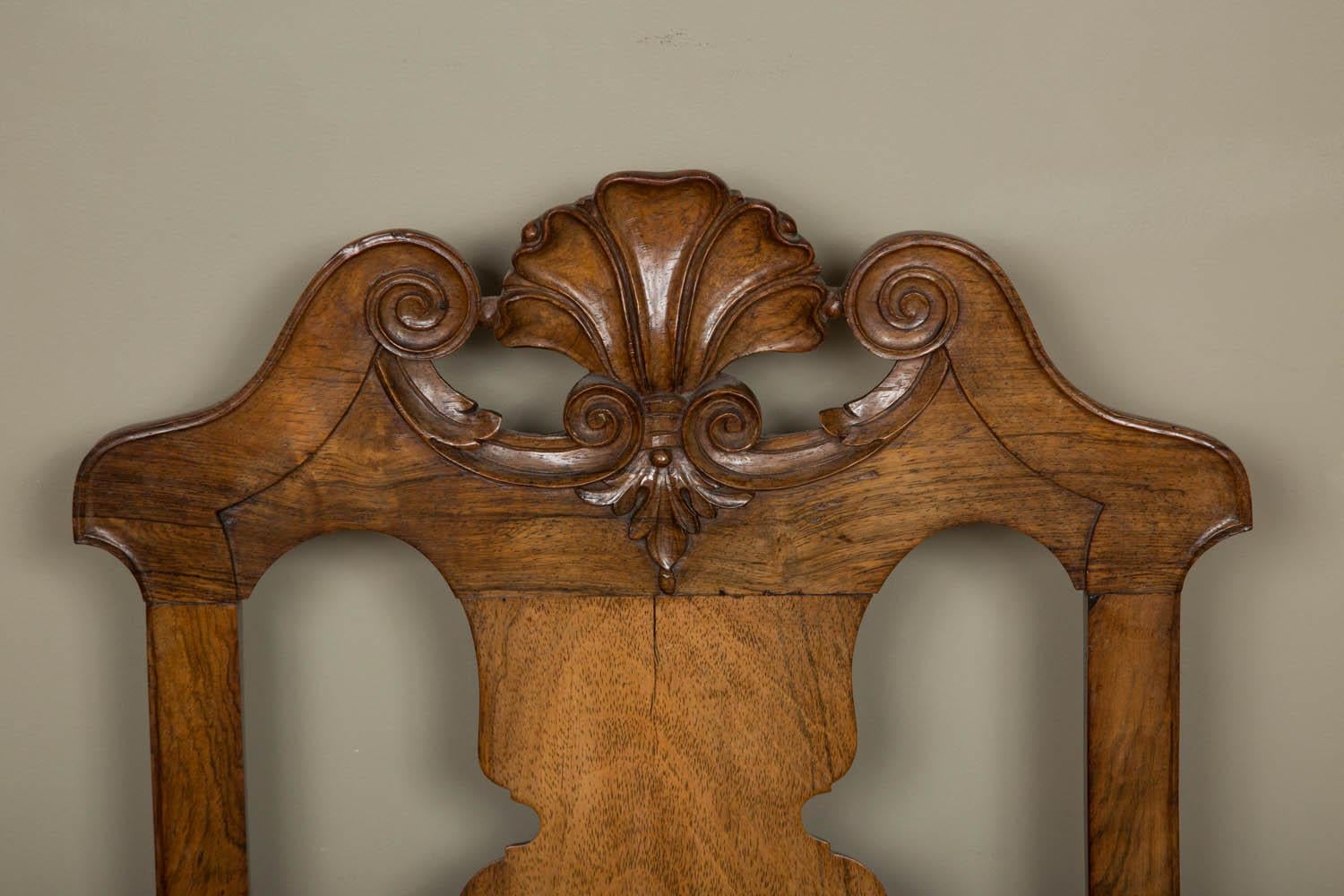 A highly decorative pair of mid-18th century Portuguese Brazilian rosewood high back chairs with beautiful scrolling pediment at the top with carved shell in the middle and on cabriole legs terminating in pad feet and ondulated stretchers.
Finely