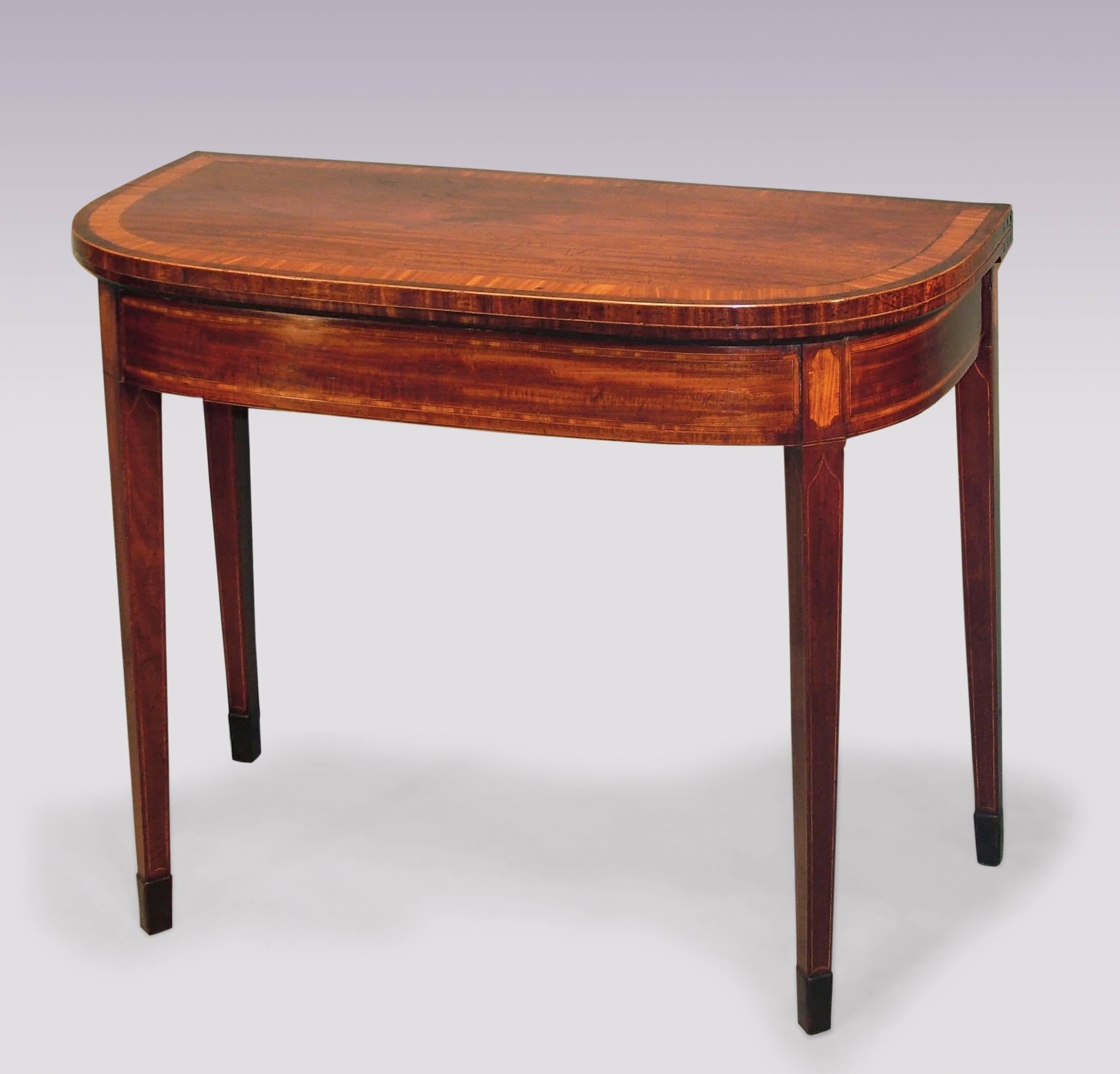 A fine pair of late 18th century Sheraton period well-figured mahogany card tables having satinwood and tulipwood crossbanded D-shaped tops above satinwood panelled friezes, supported on boxwood line-inlaid square tapering legs ending on spade feet.