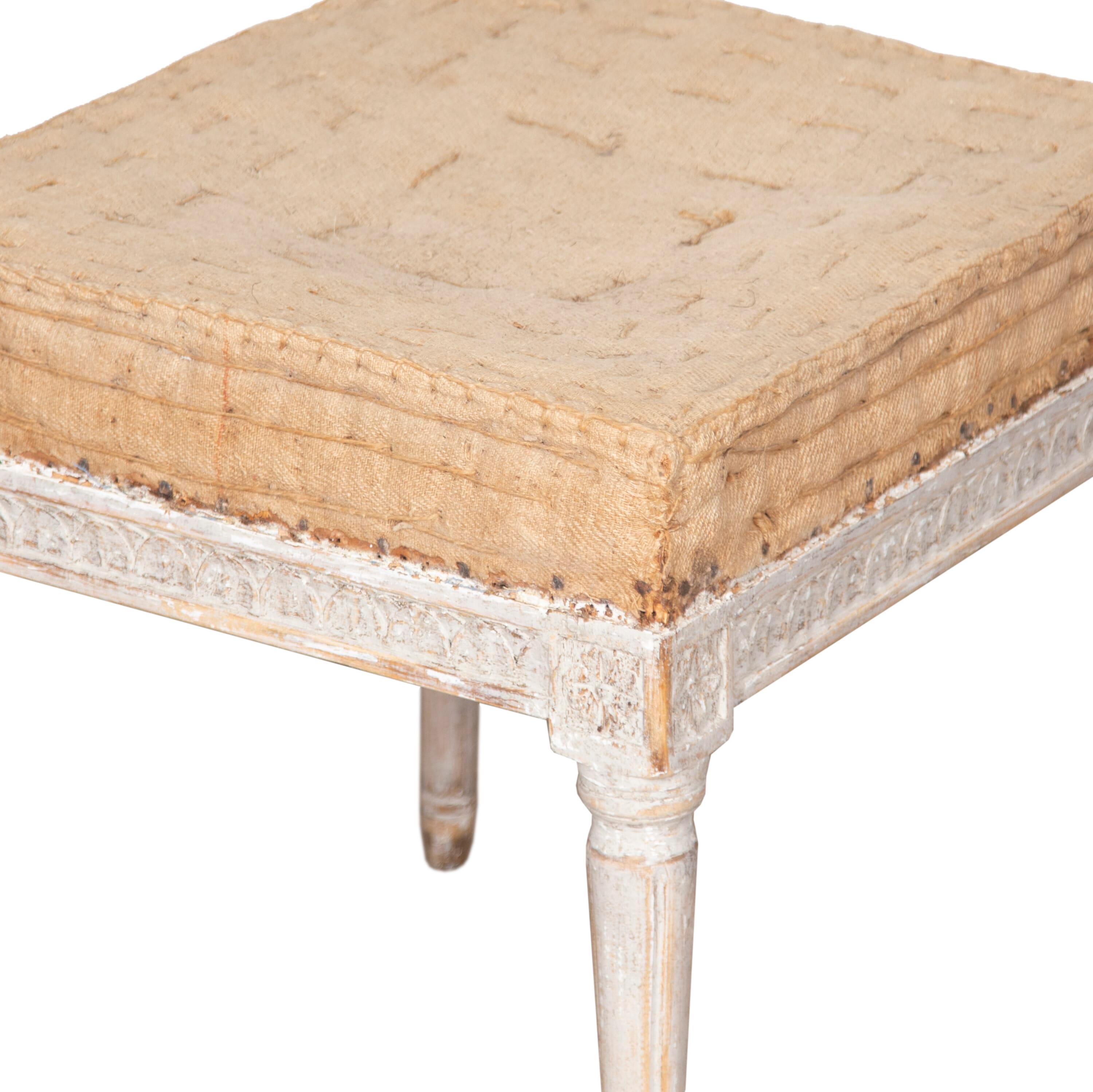 Period pair of 18th century Stockholm made pair of Gustavian footstools.
Repainted in soft grey with decorative carved detailing to the stretchers and legs. 
Circa 1780.