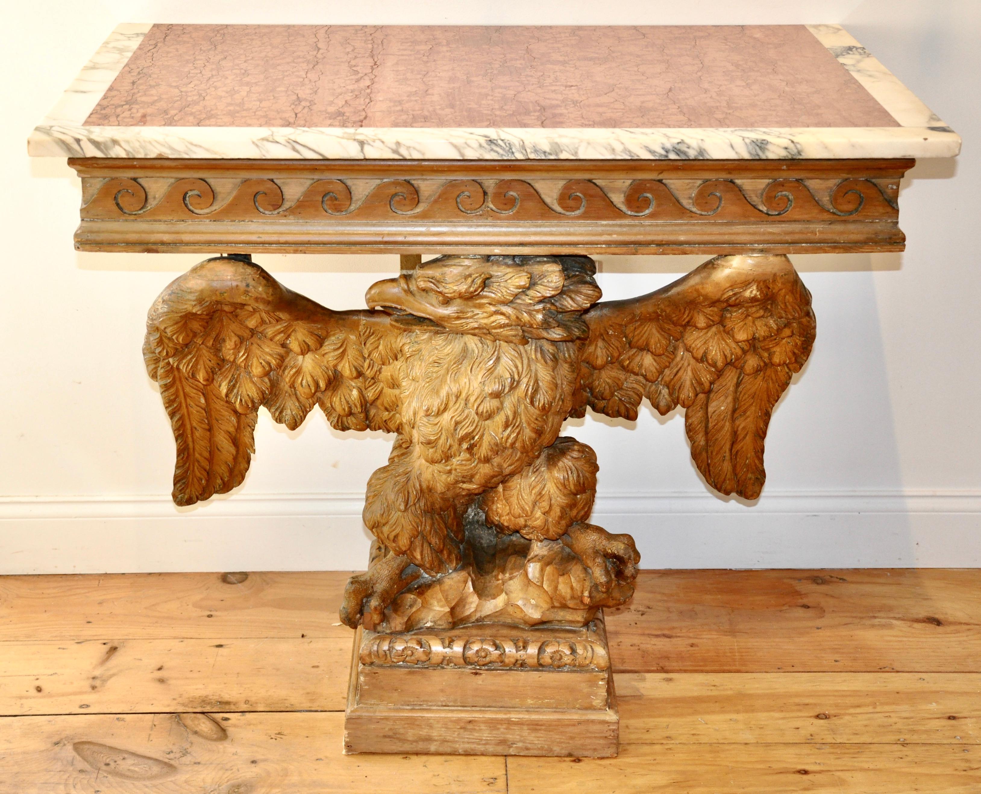 Pair of Early to Mid-18th Century George II Marble Top Eagle Console Tables in Manner of William Kent

Well carved eagles clutching rocks. Wings spread. Top frieze in Neoclassical Running Dog Motif. Early if not original orange marble with white