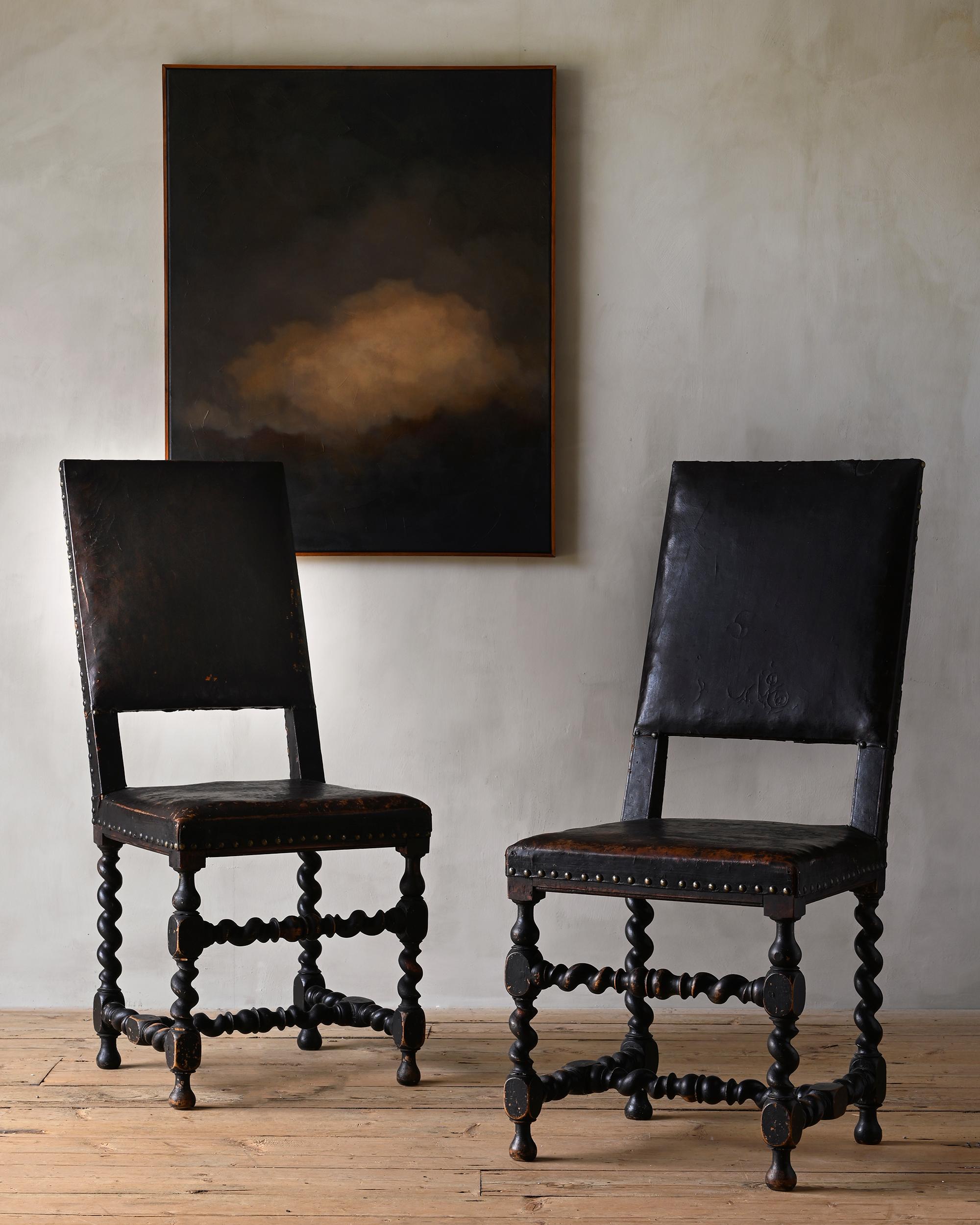 Fine and very rare pair of early 18th century Swedish Baroque chairs in their original finish, circa 1700 Sweden. Leather is original with some historical repairs.